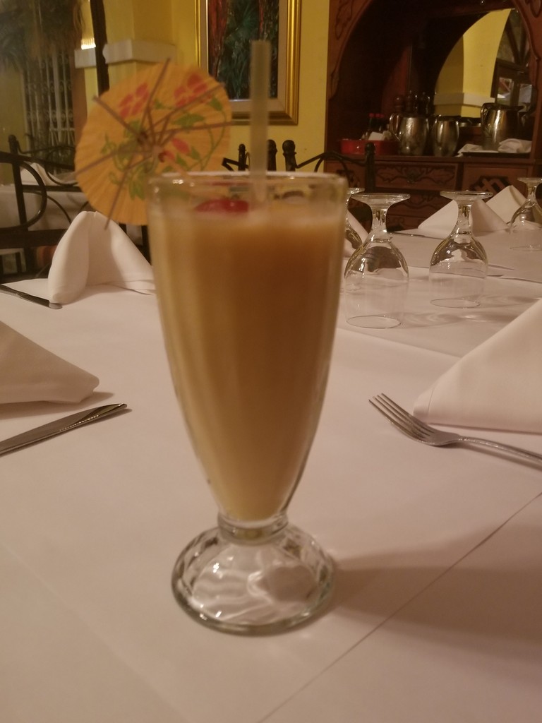 a glass of milkshake on a table