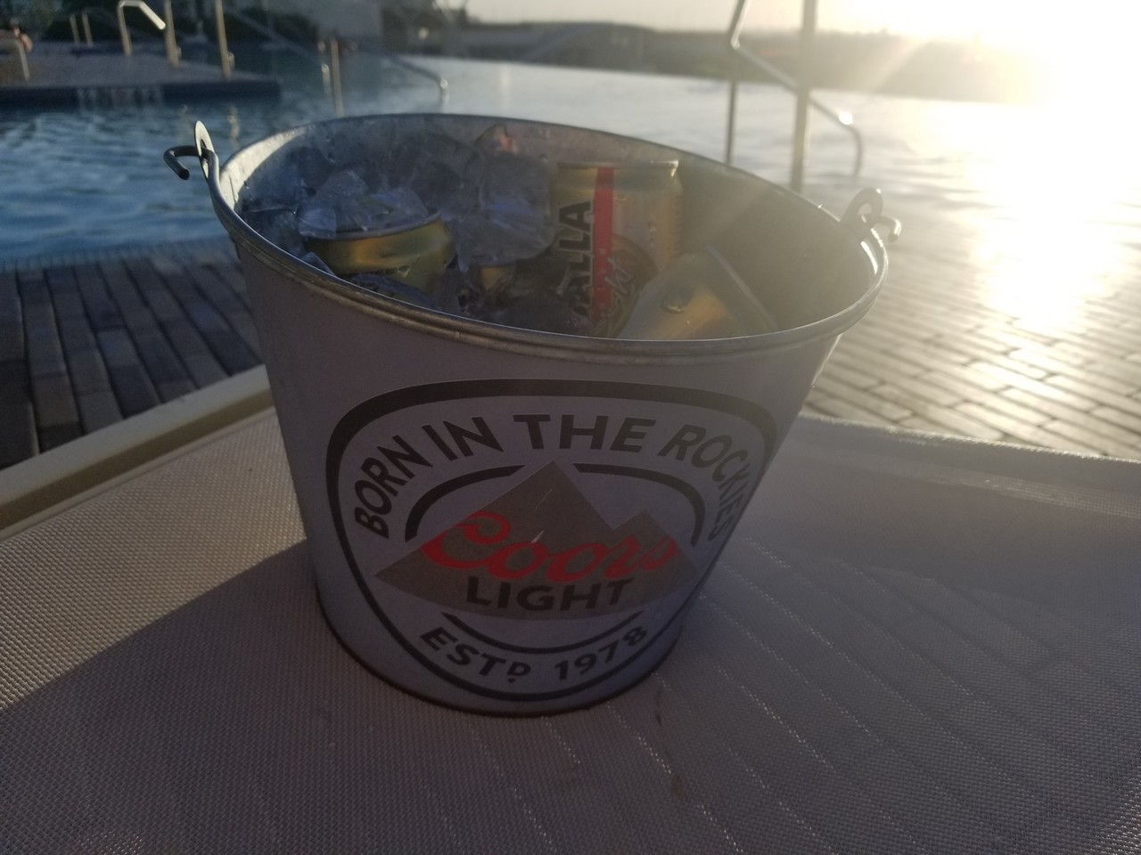 a bucket of cans and cans on a dock