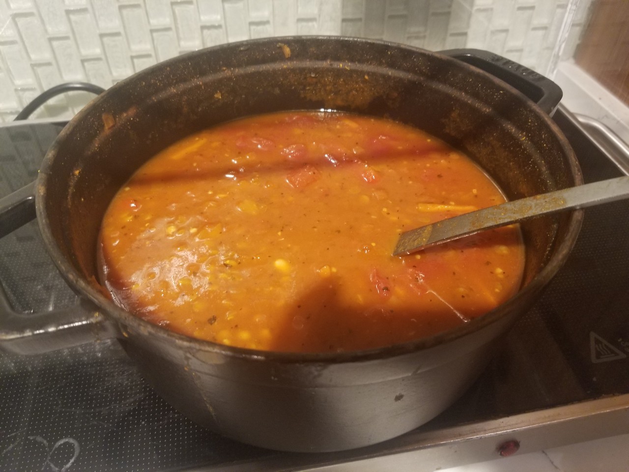 a pot of soup with a spoon