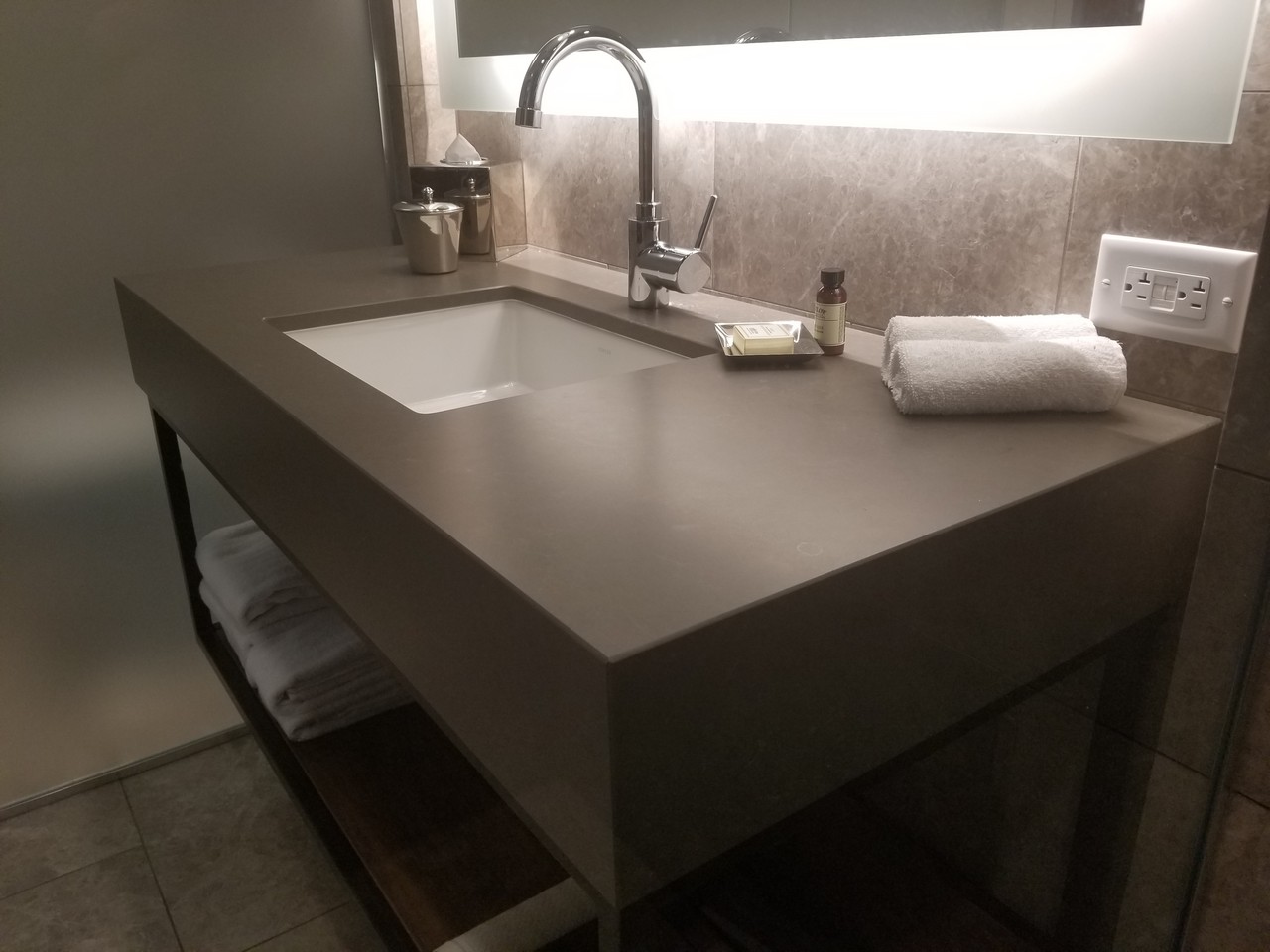 a sink with a faucet and towels on it