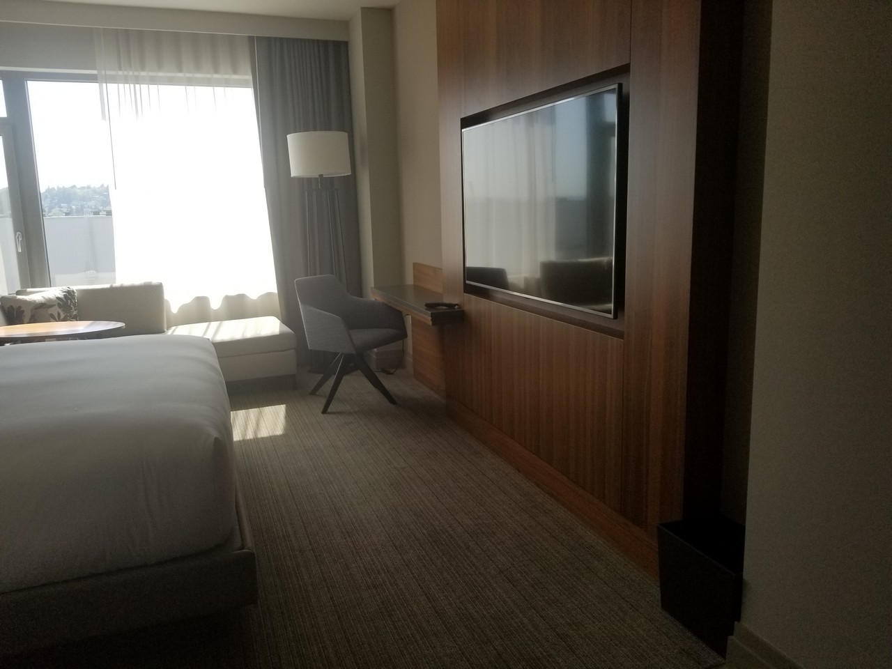 a room with a bed and a television