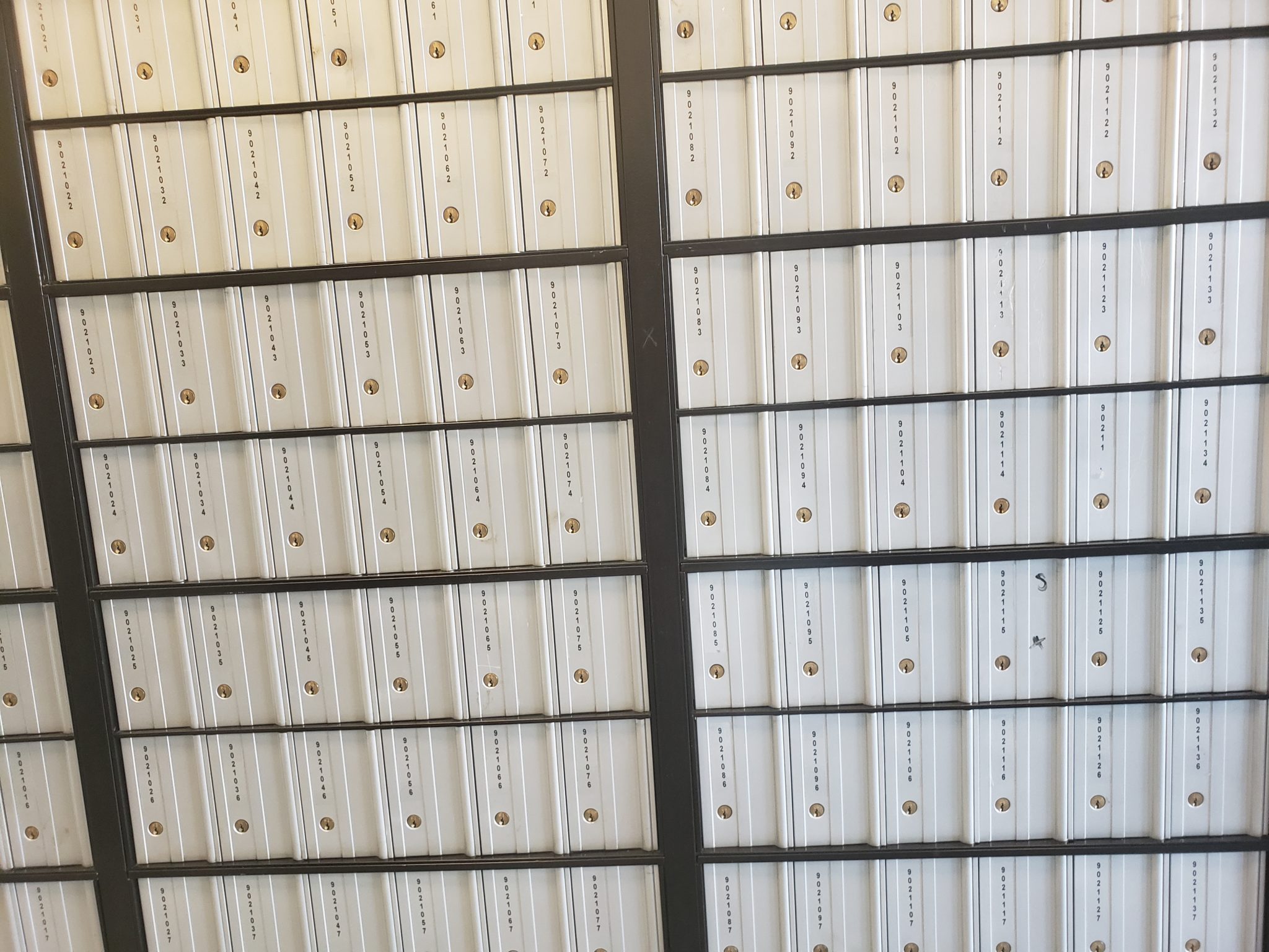 a group of white boxes with gold screws