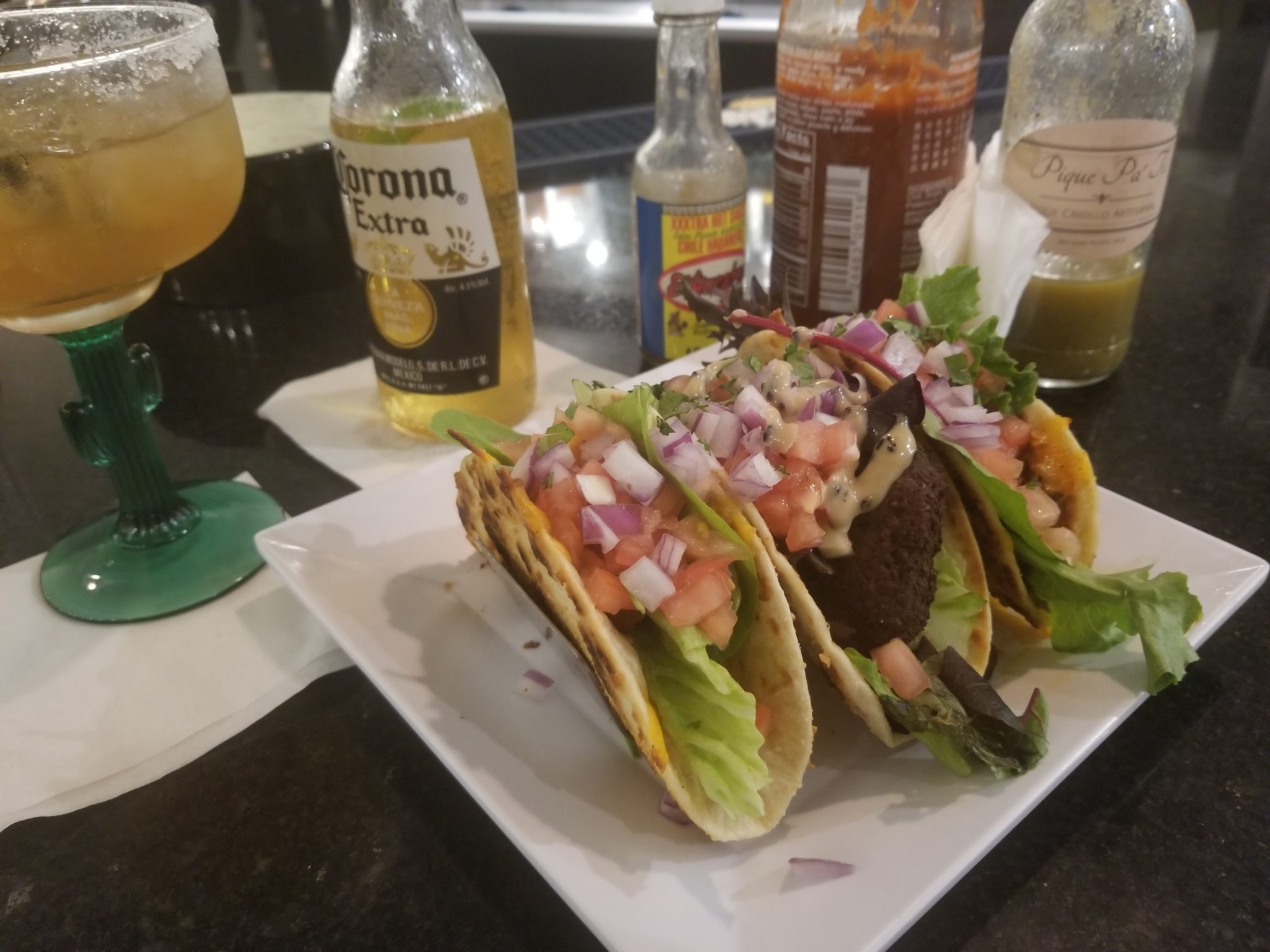 a plate of tacos and drinks