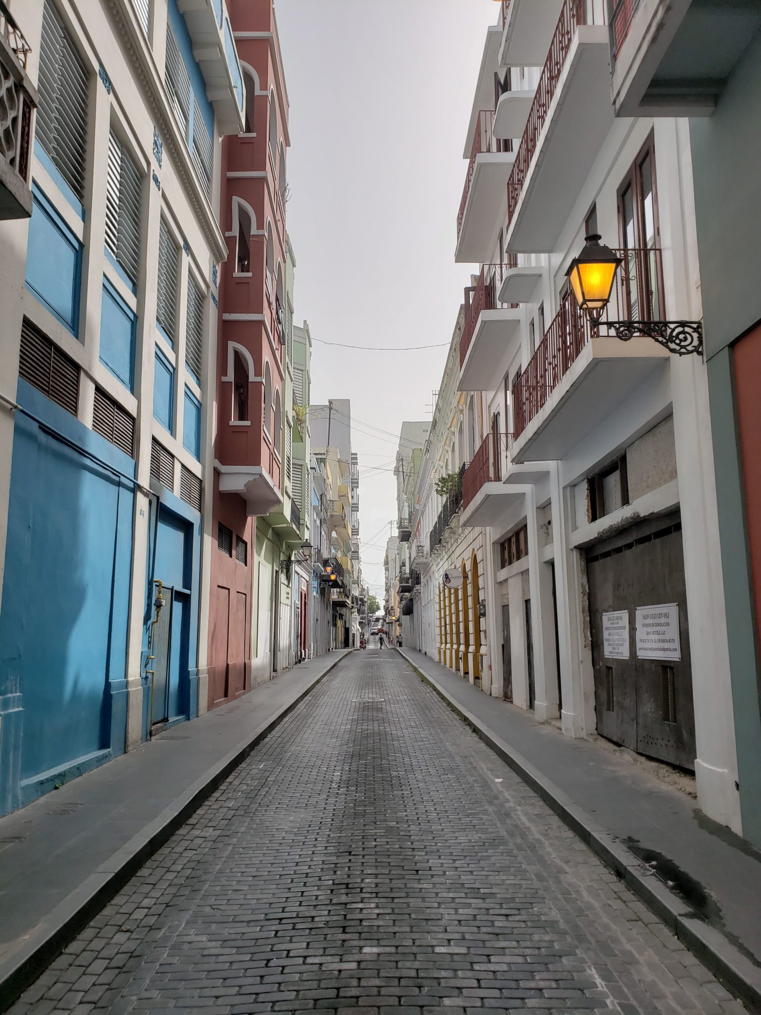 a street with buildings and a lamp