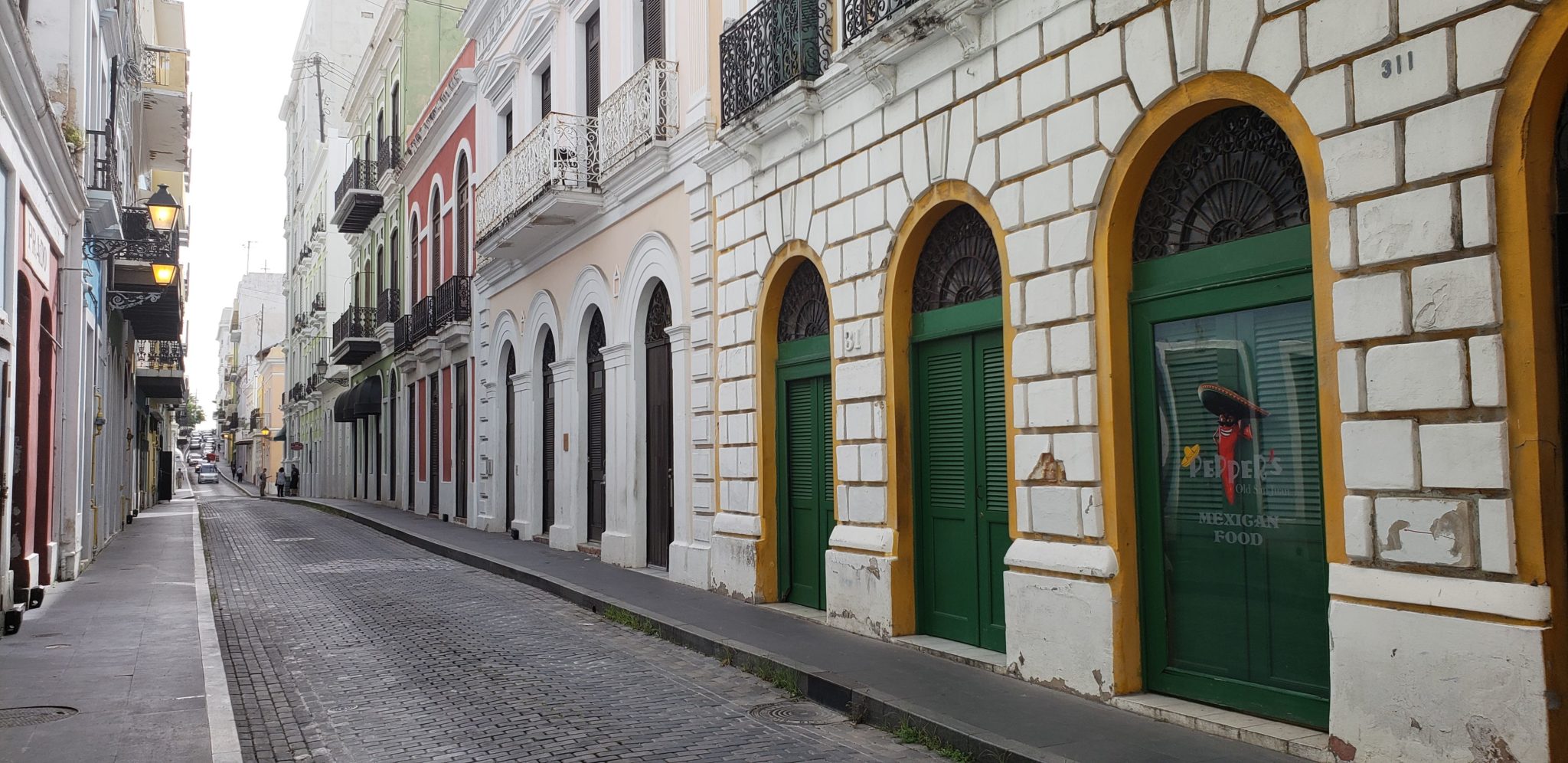 a row of buildings with green doors