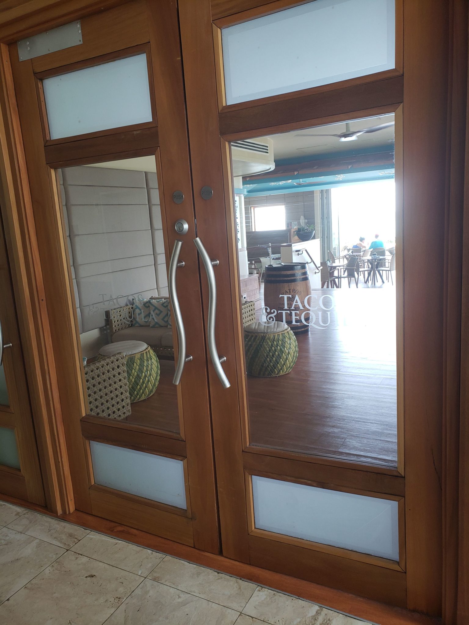 a glass doors with a mirror on the side