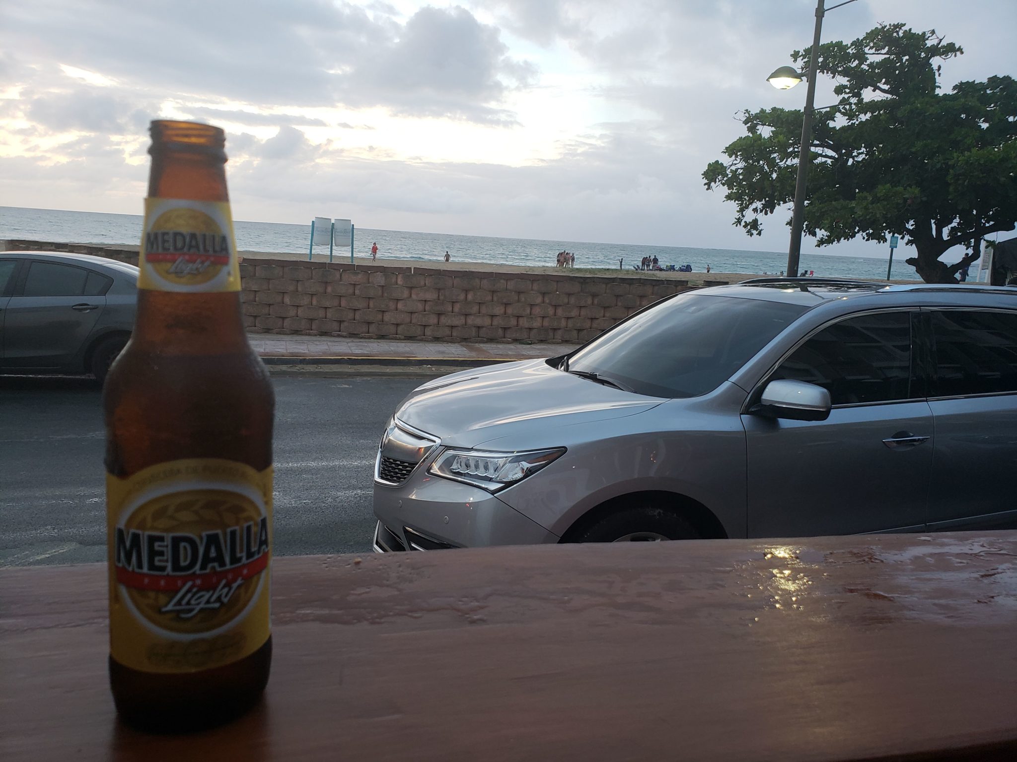 a beer bottle and a car on a table