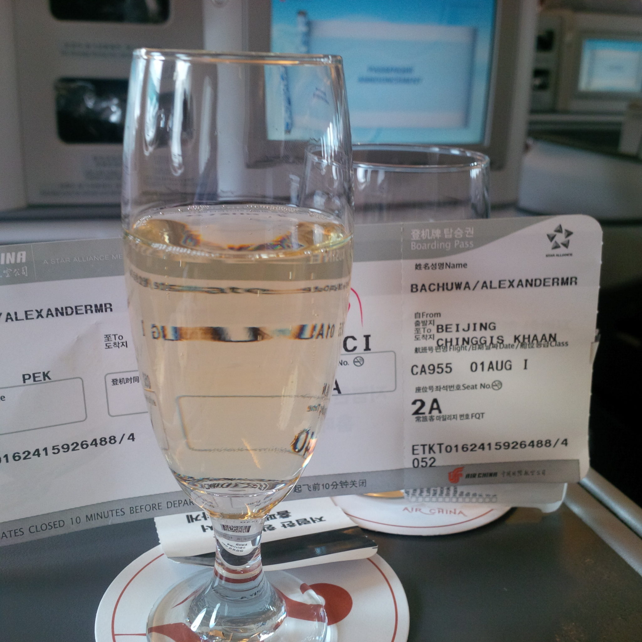 a glass of champagne next to a ticket