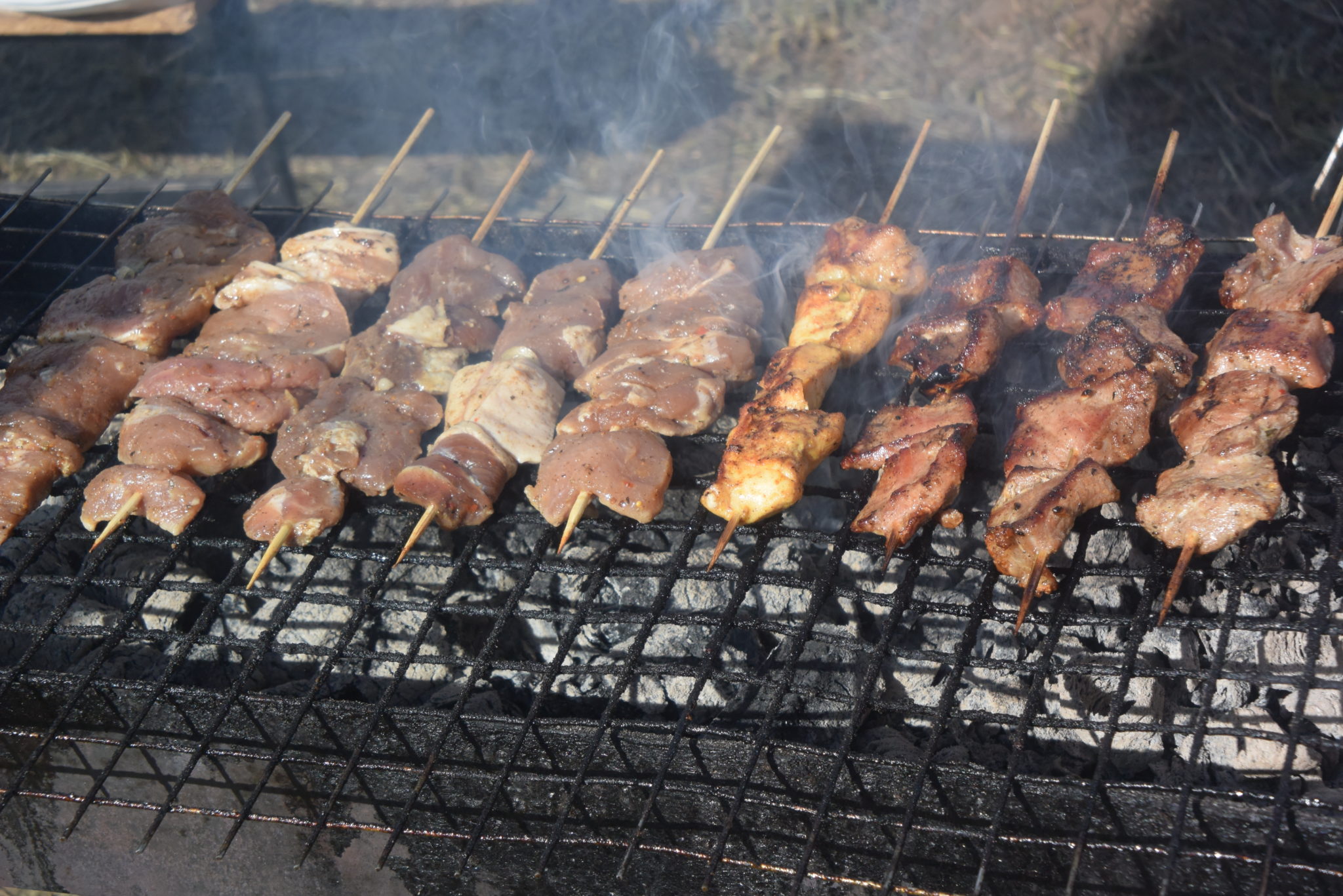 meat on skewers on a grill