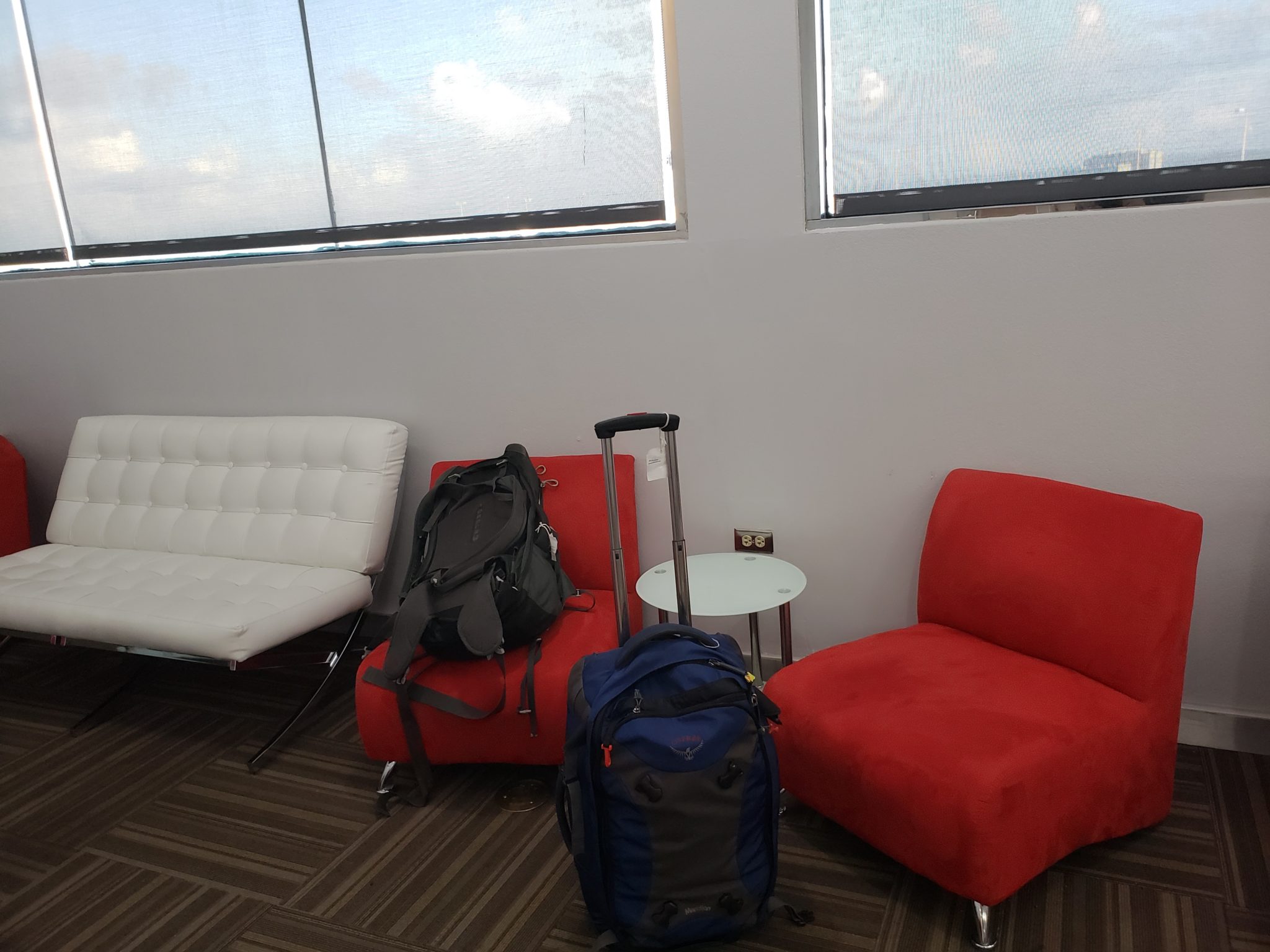a red chair and luggage in a room