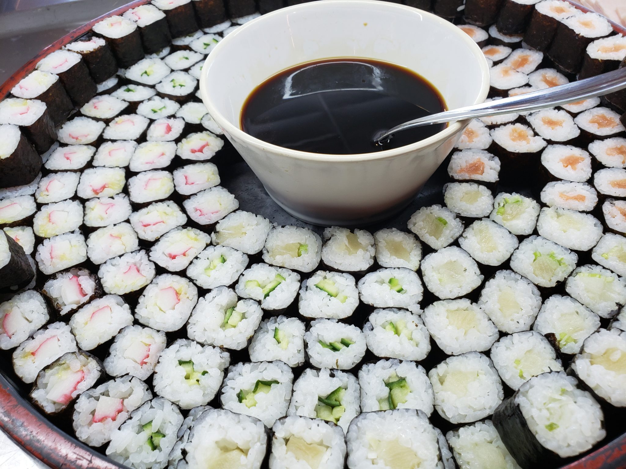 a bowl of soy sauce and sushi