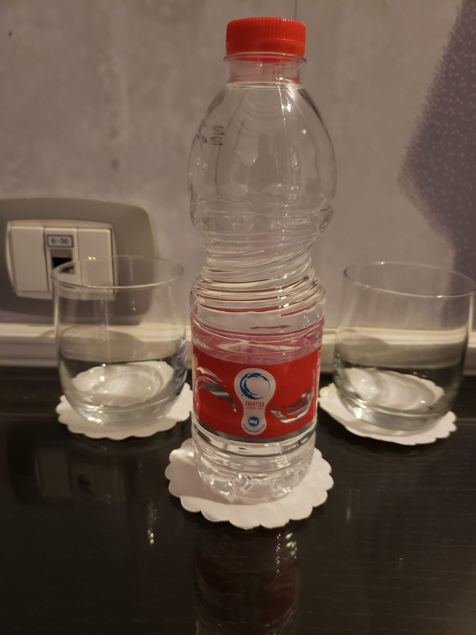 a bottle of water on a coaster