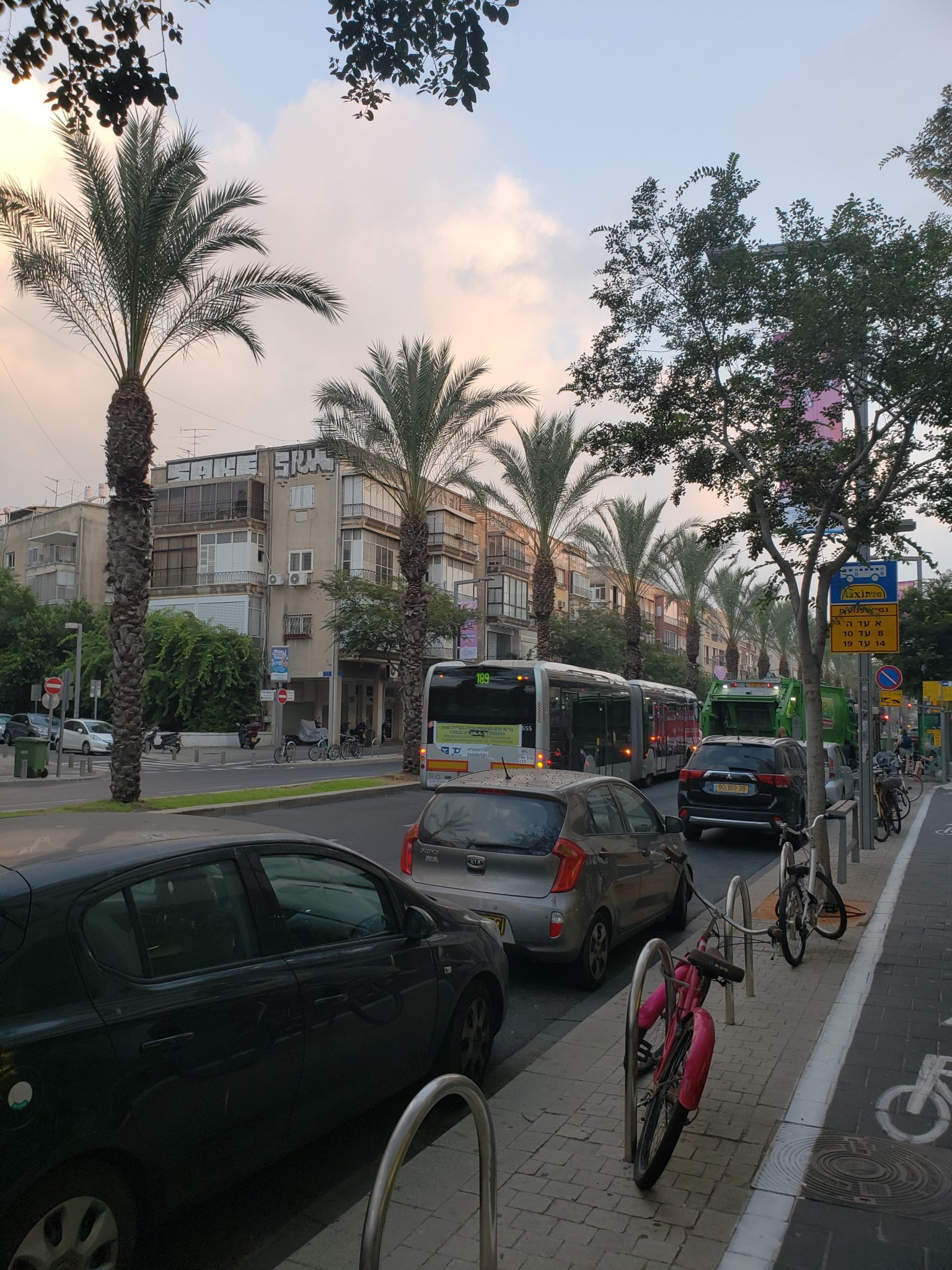a street with cars and bicycles on the side