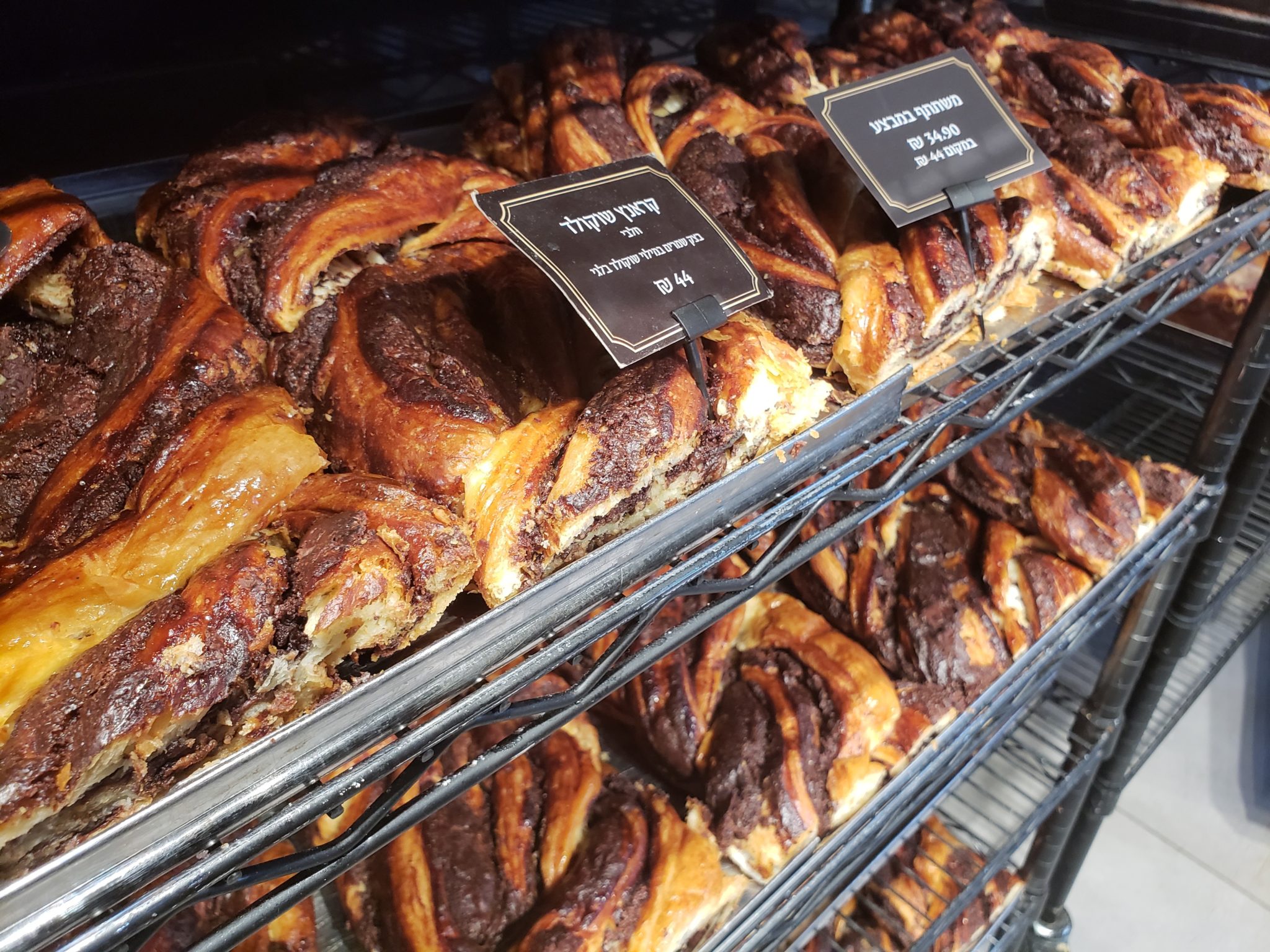 a rack of pastries with signs on it