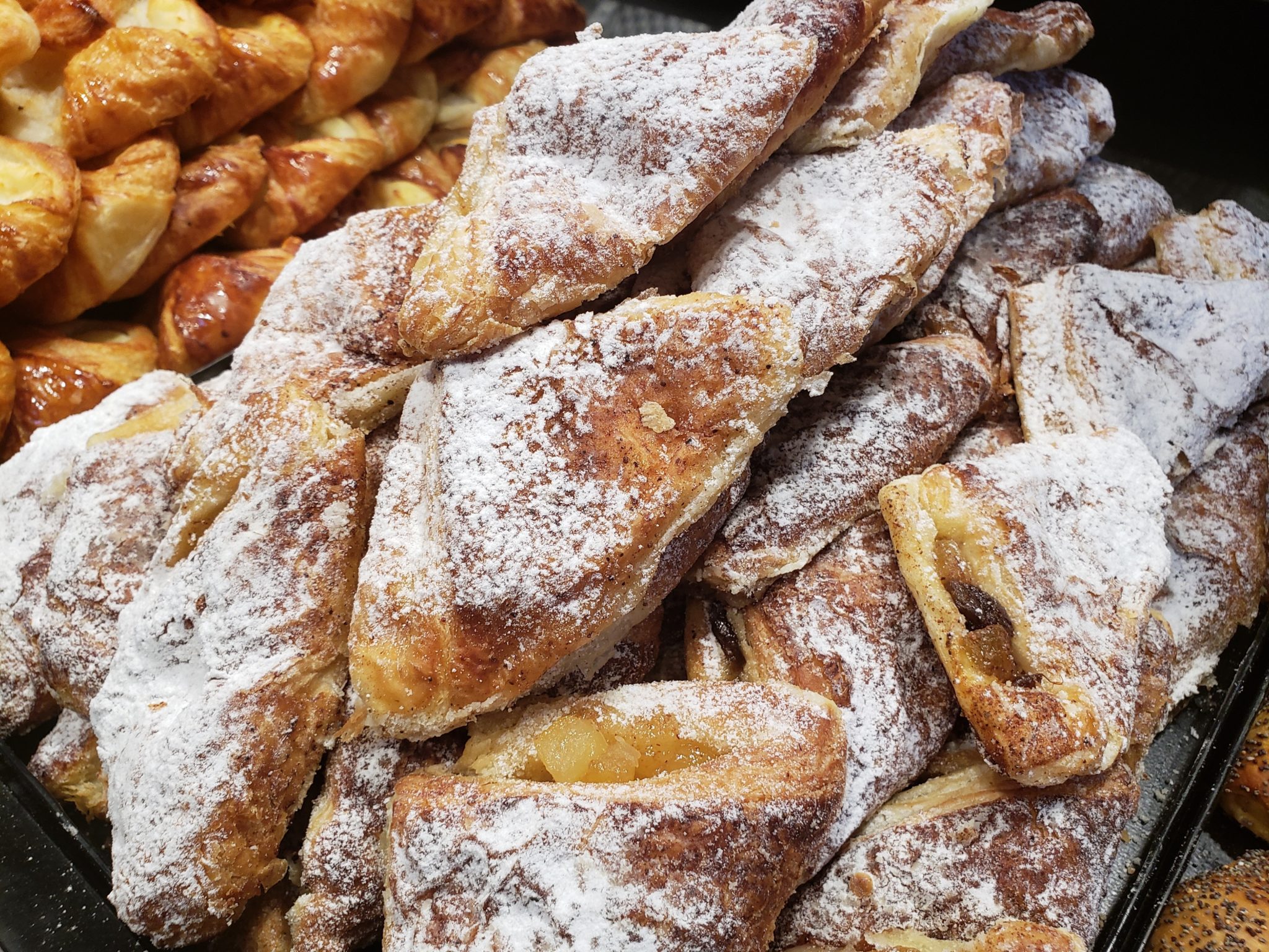 a pile of pastries with powdered sugar