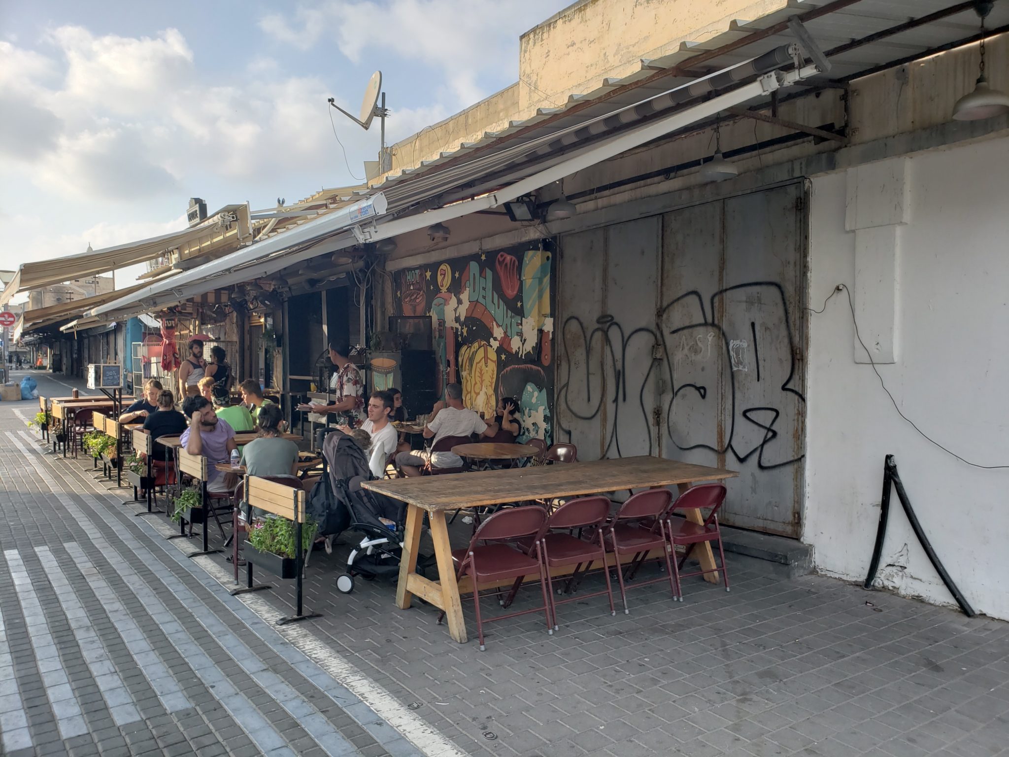 a group of people sitting at tables outside a building