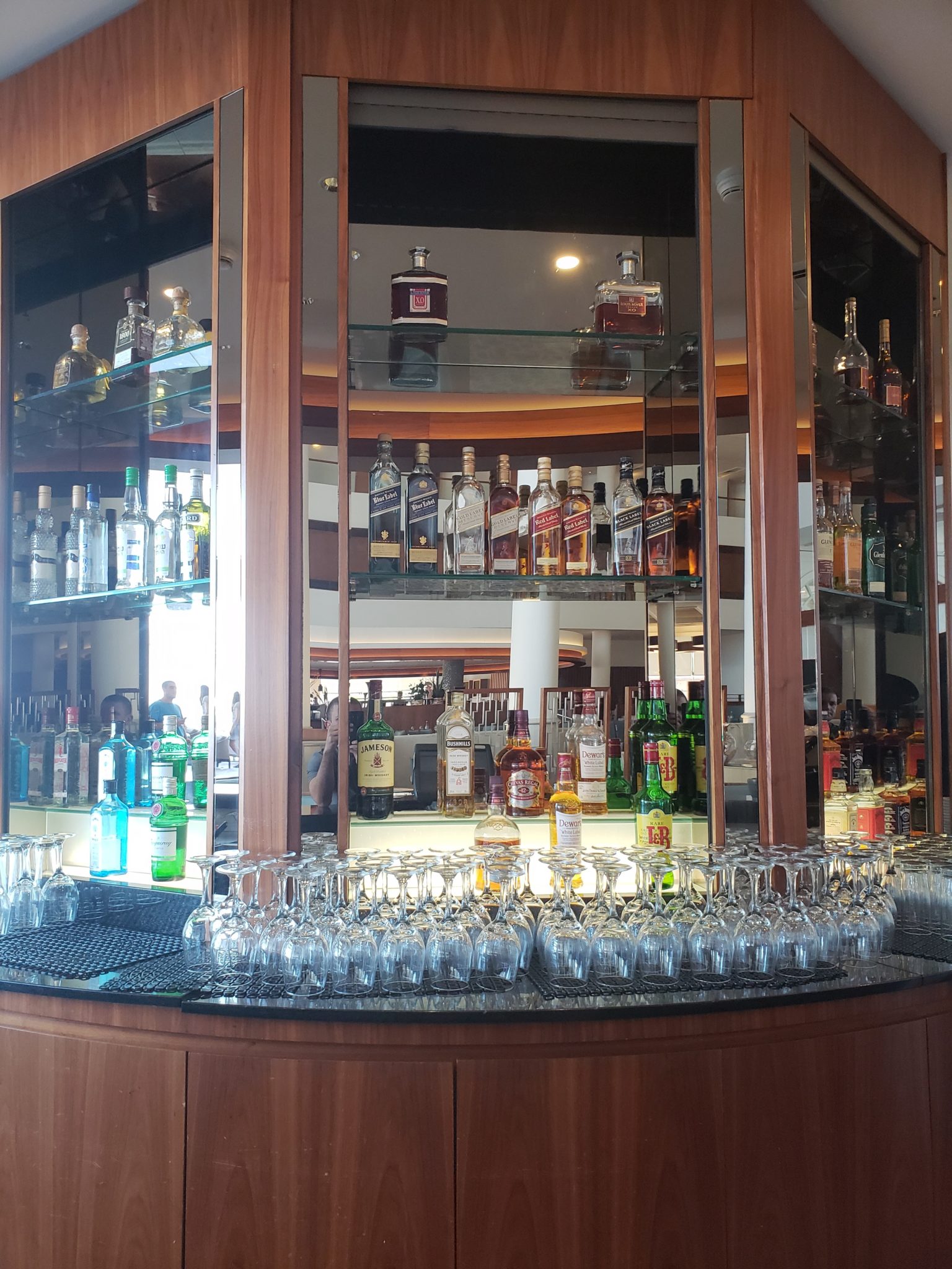a bar with many glasses and bottles of alcohol