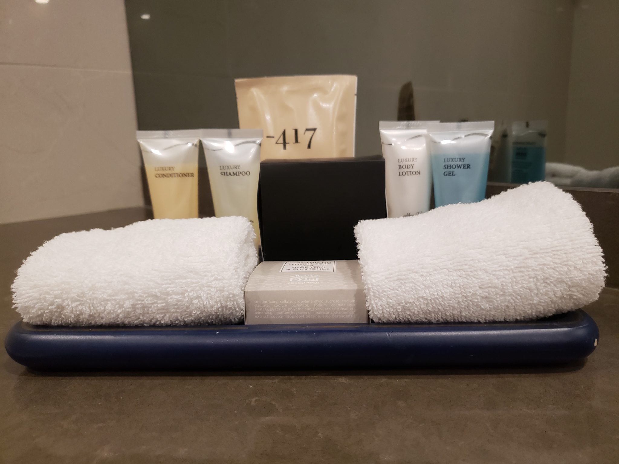 a group of towels and a box of shampoo