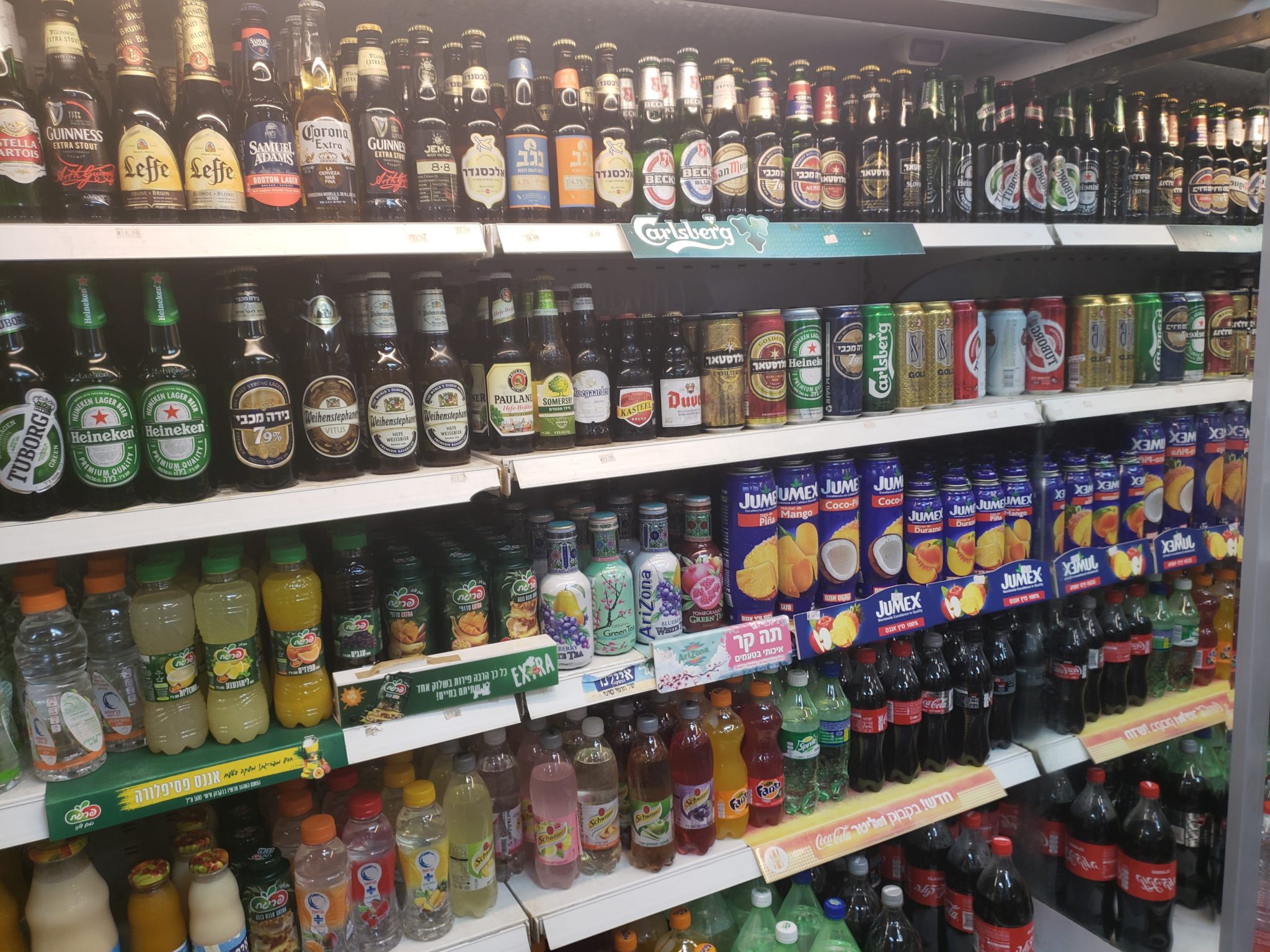 a shelf with bottles of beverages