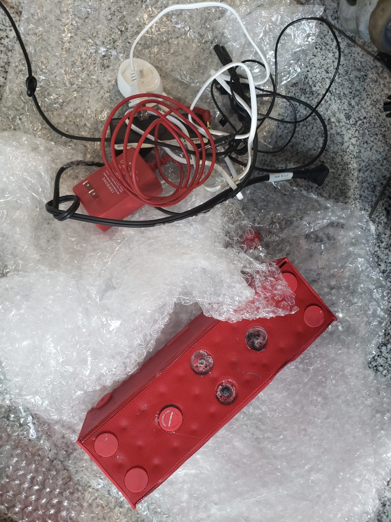 a red box with wires and wires on a surface