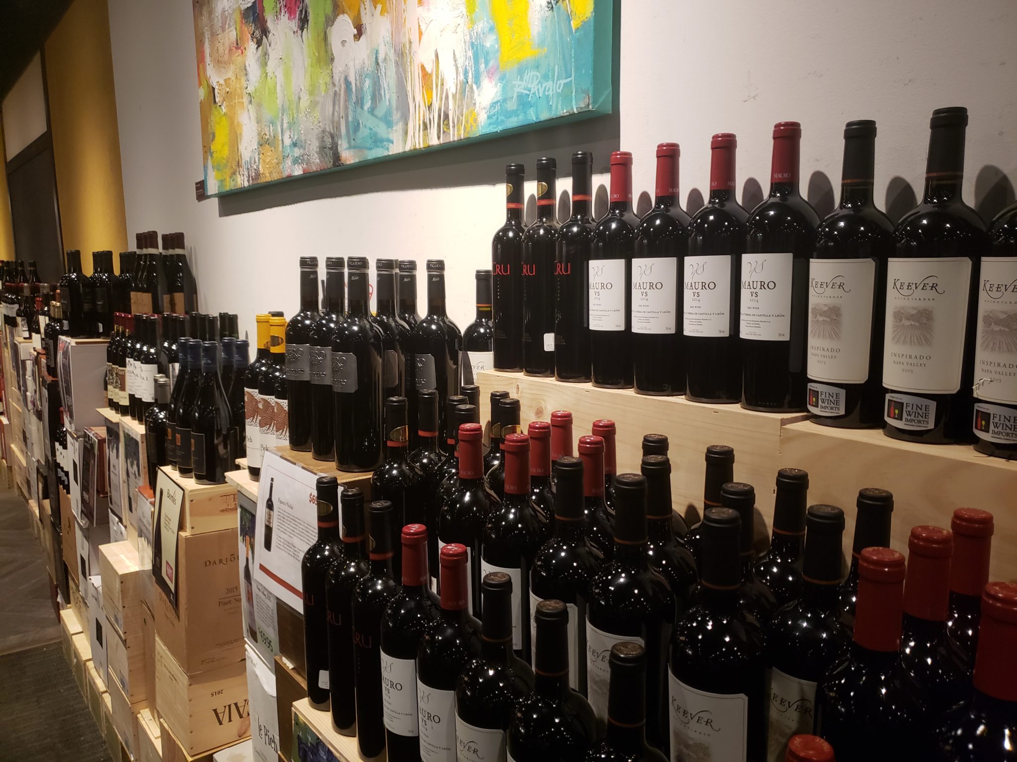 a shelf of wine bottles