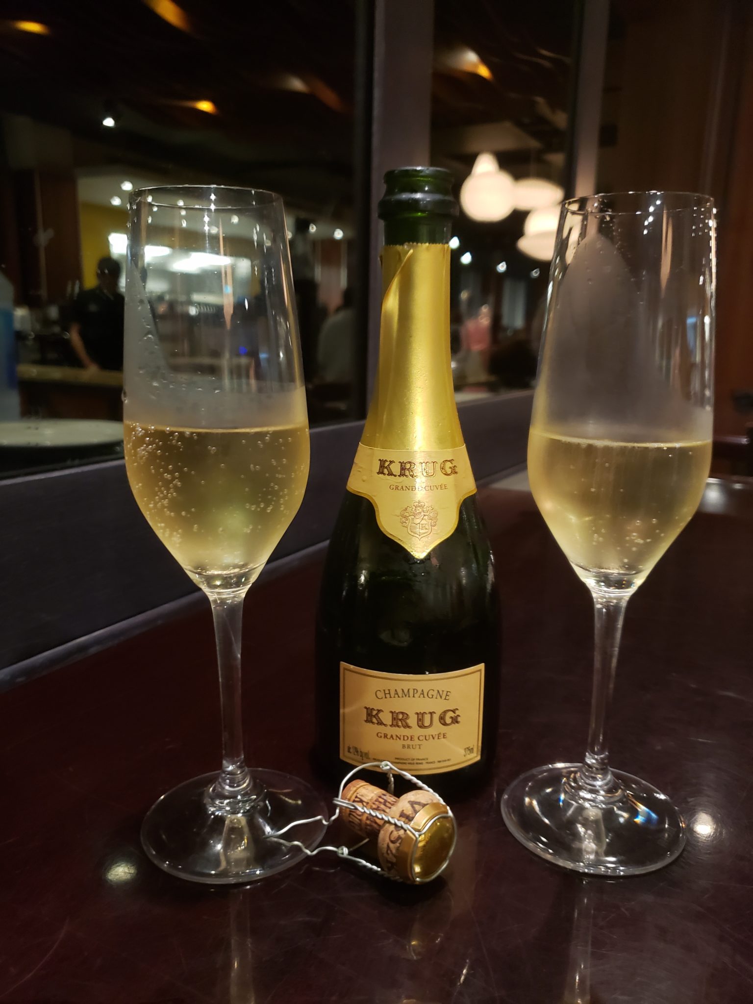 a bottle of champagne and two wine glasses