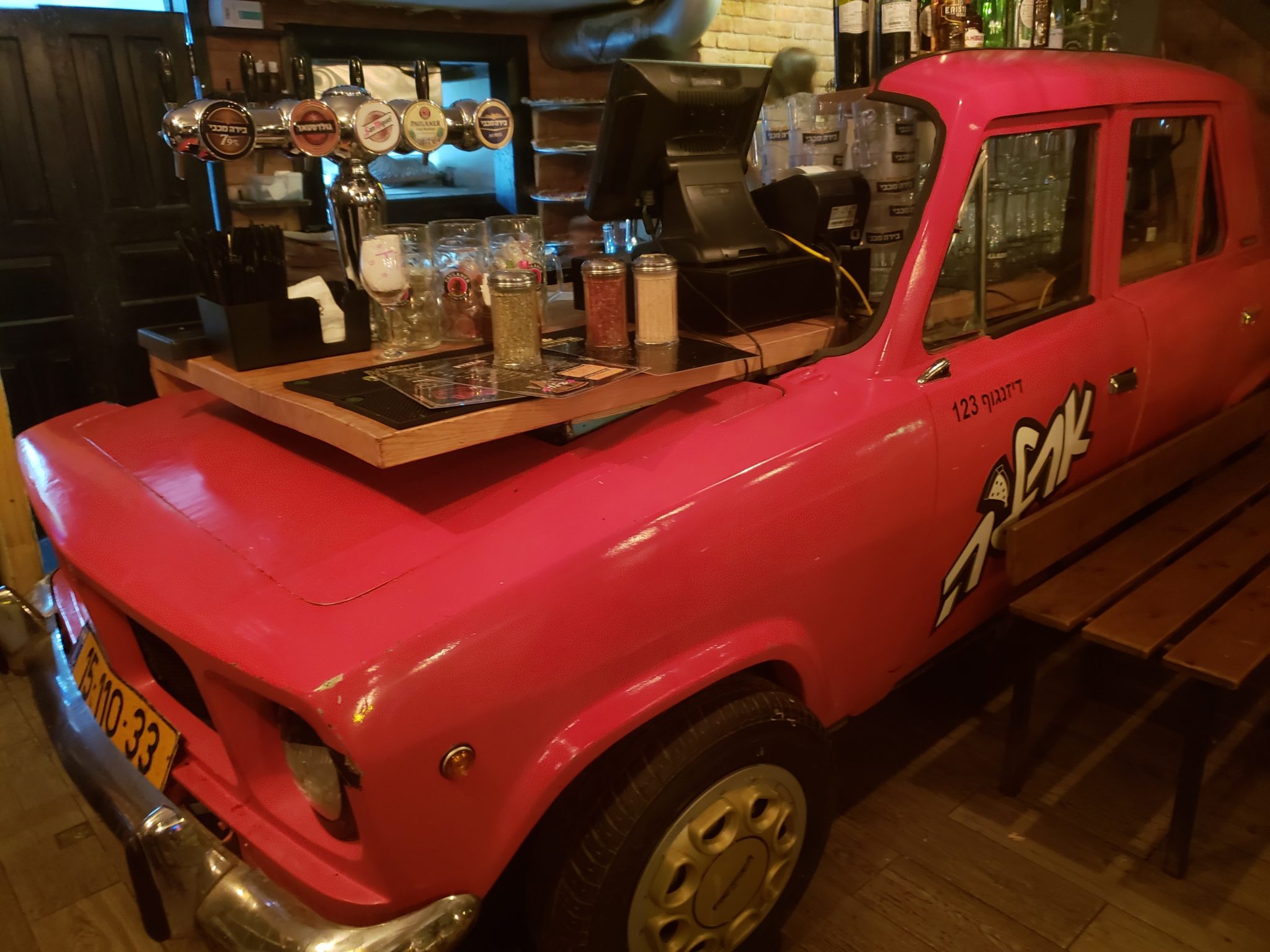 a pink truck with a bar on the hood