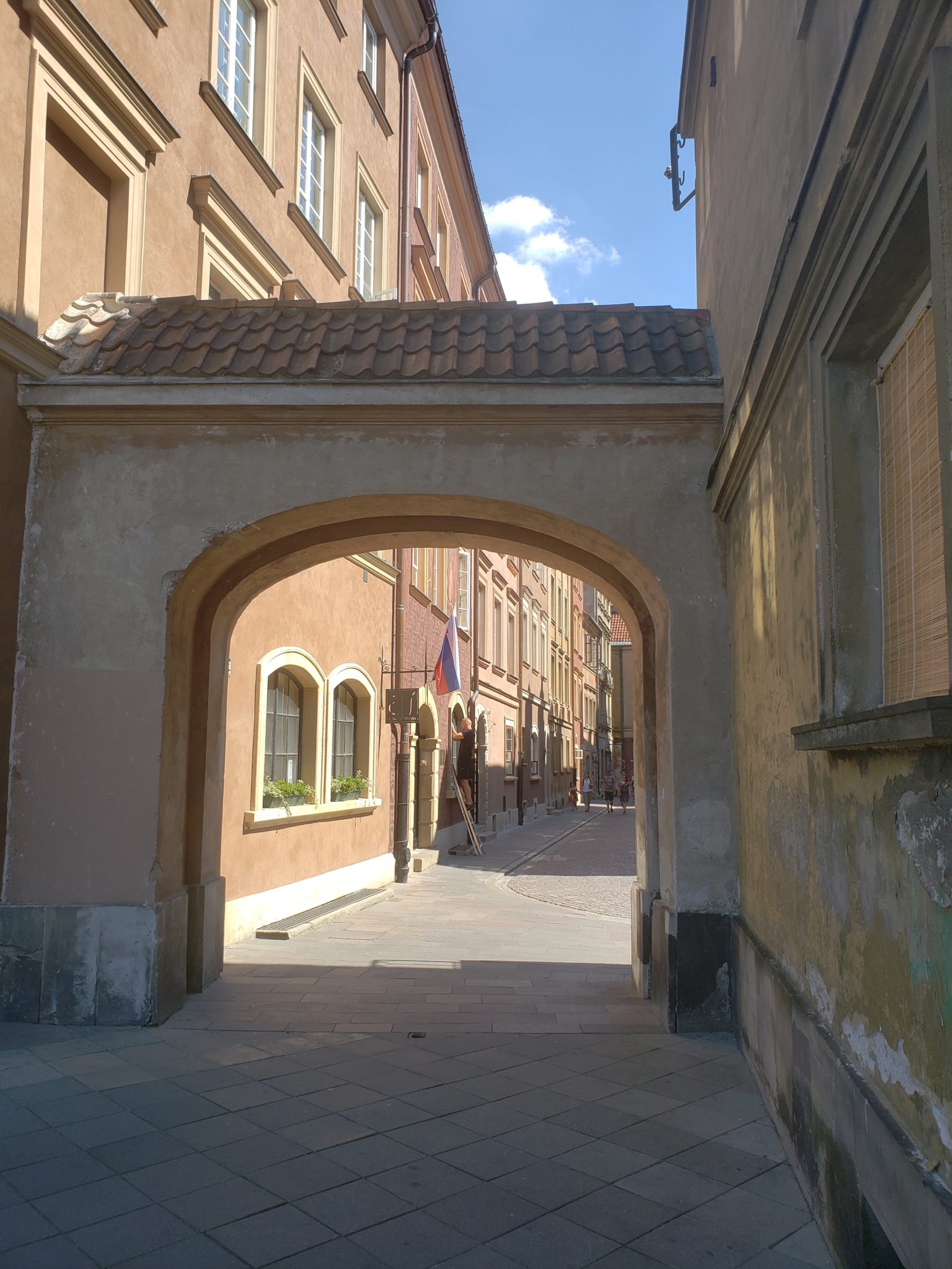 a stone archway between buildings