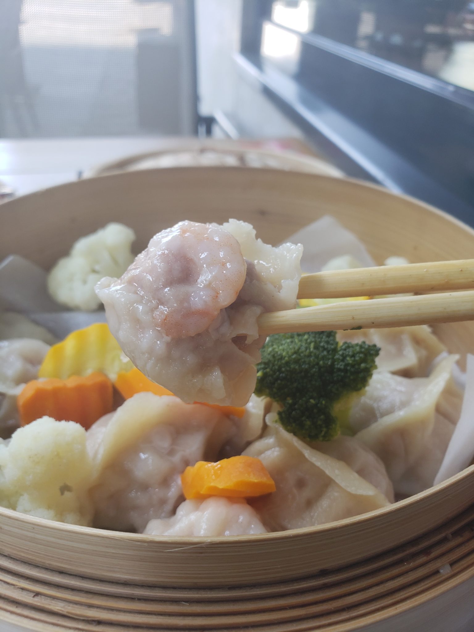 a bowl of food with chopsticks