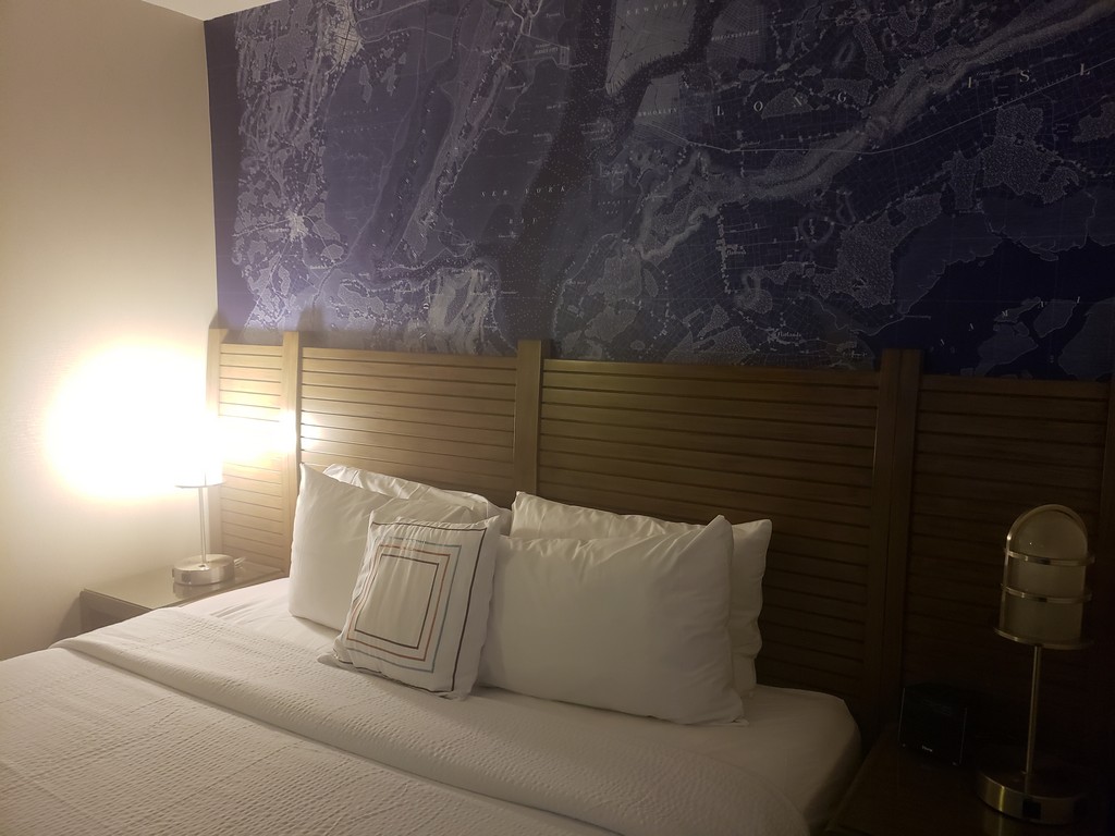 a bed with a map on the wall