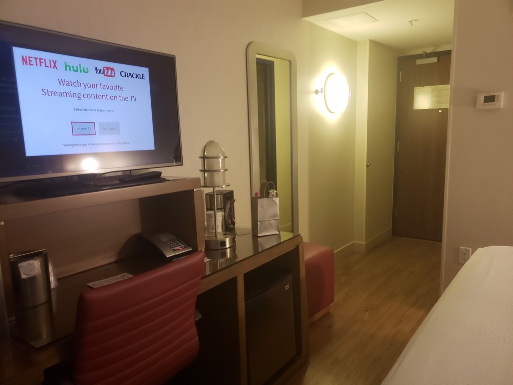 a tv on a desk in a hotel room