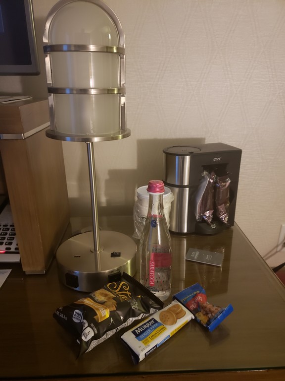 a table with a lamp and snacks on it