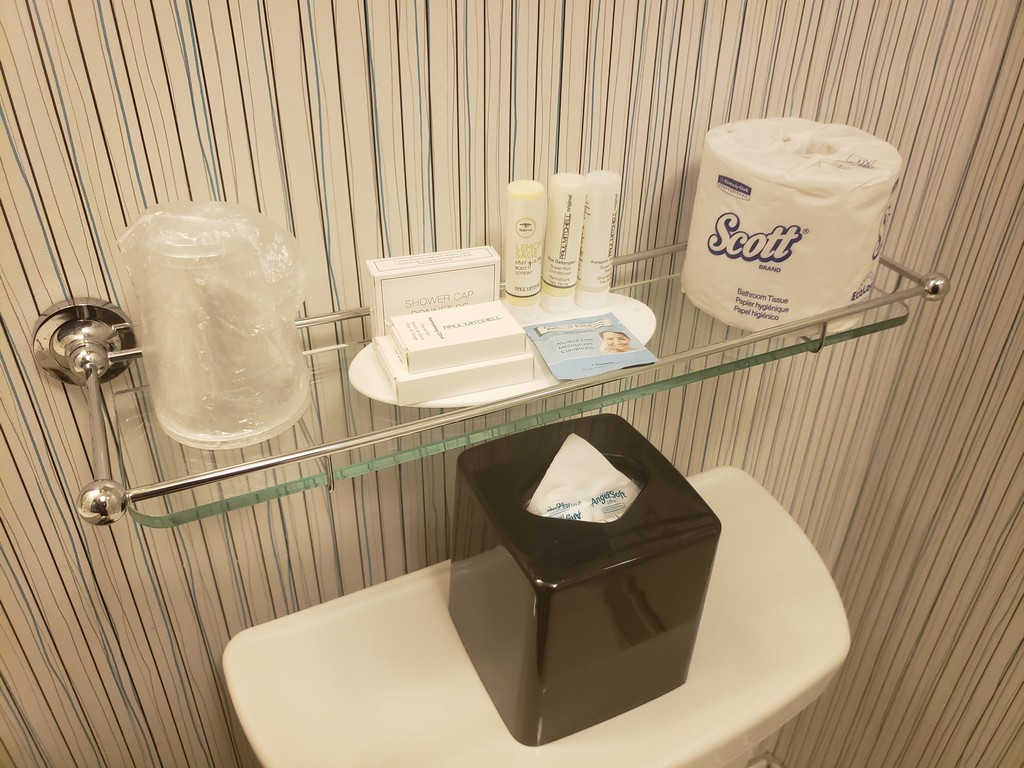 a shelf with a variety of toilet paper and other items