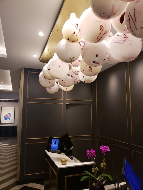 a white and pink balloons from the ceiling