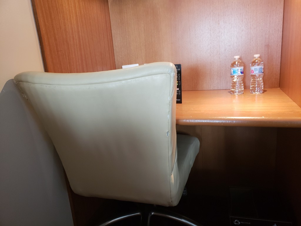 a chair and two bottles of water on a table