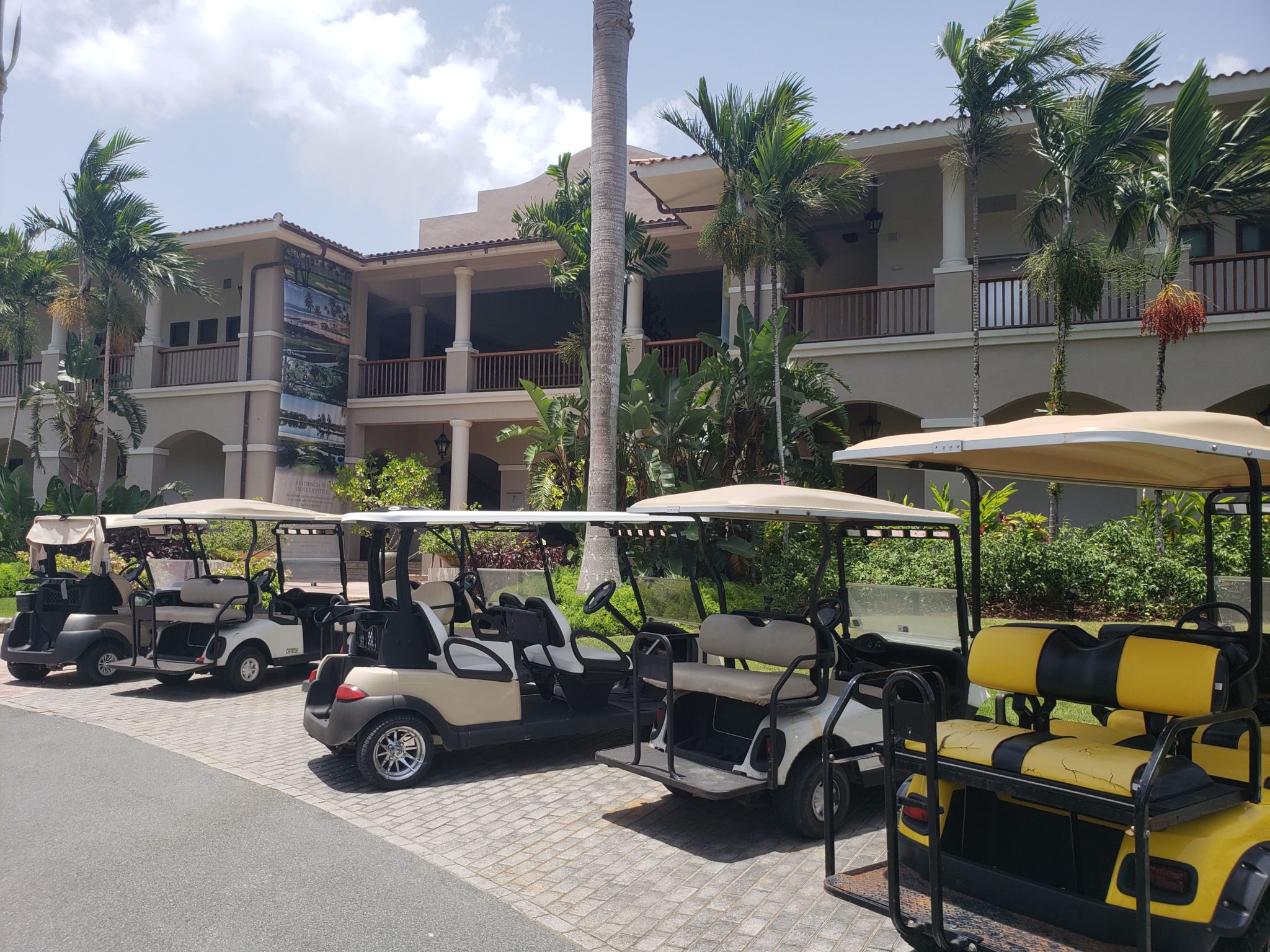 a group of golf carts parked in front of a building