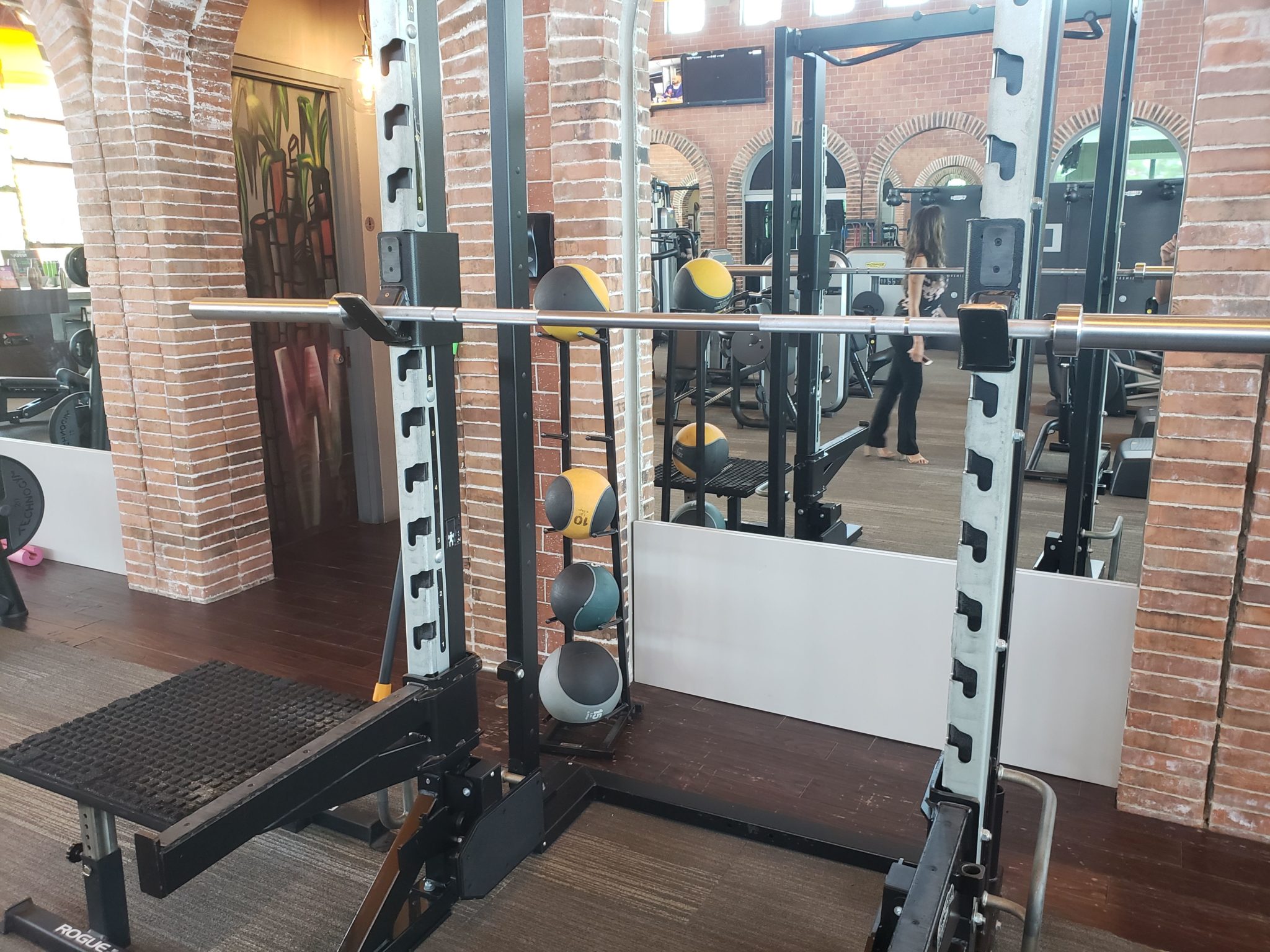 a gym with weights and a mirror