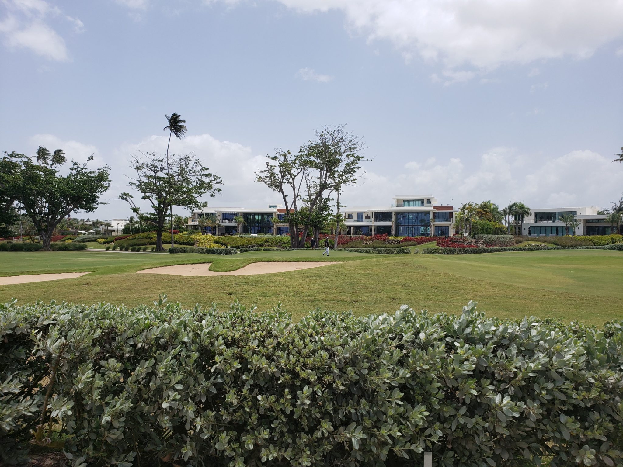 a golf course with a building and trees