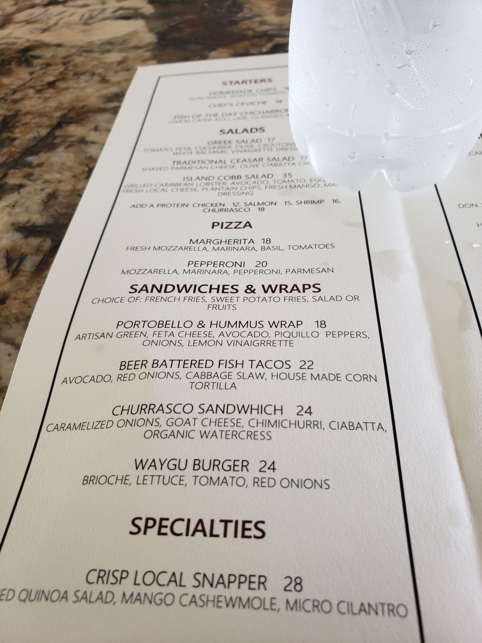 a menu with a bottle of water