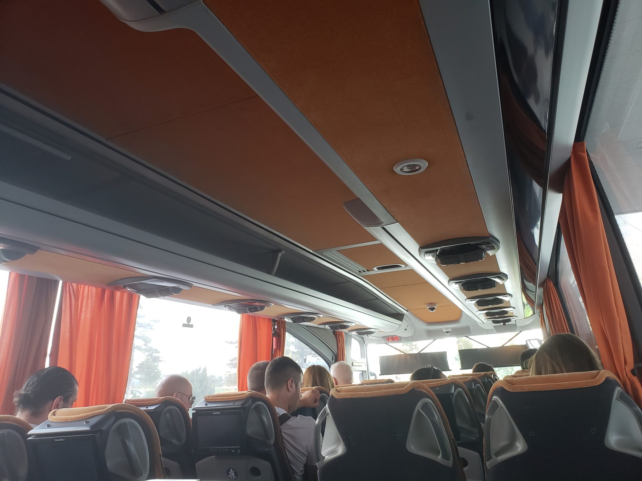 inside a bus with people sitting on seats