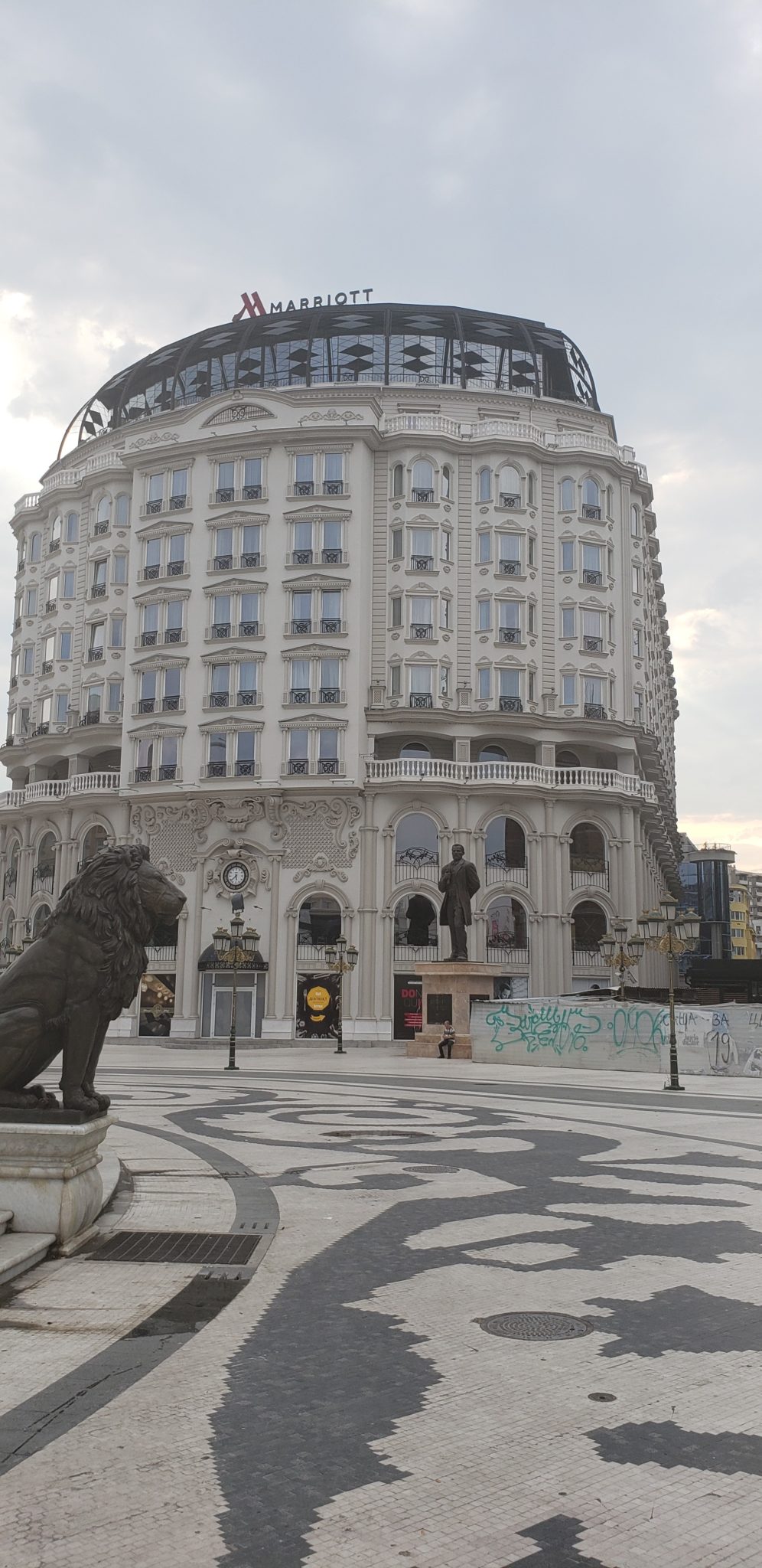 a large building with a statue of a lion in front of it