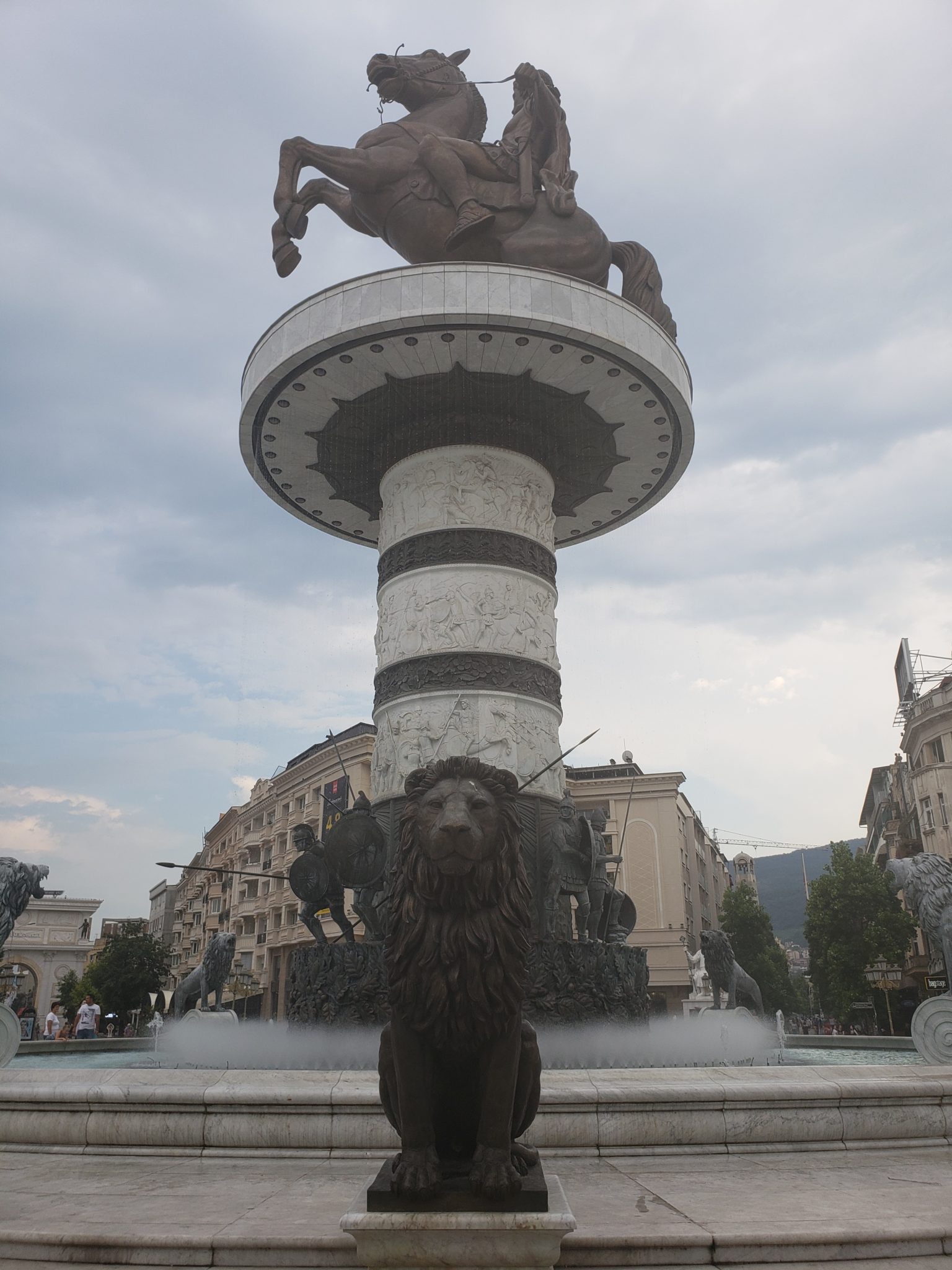 a statue of a man riding a horse on a pillar