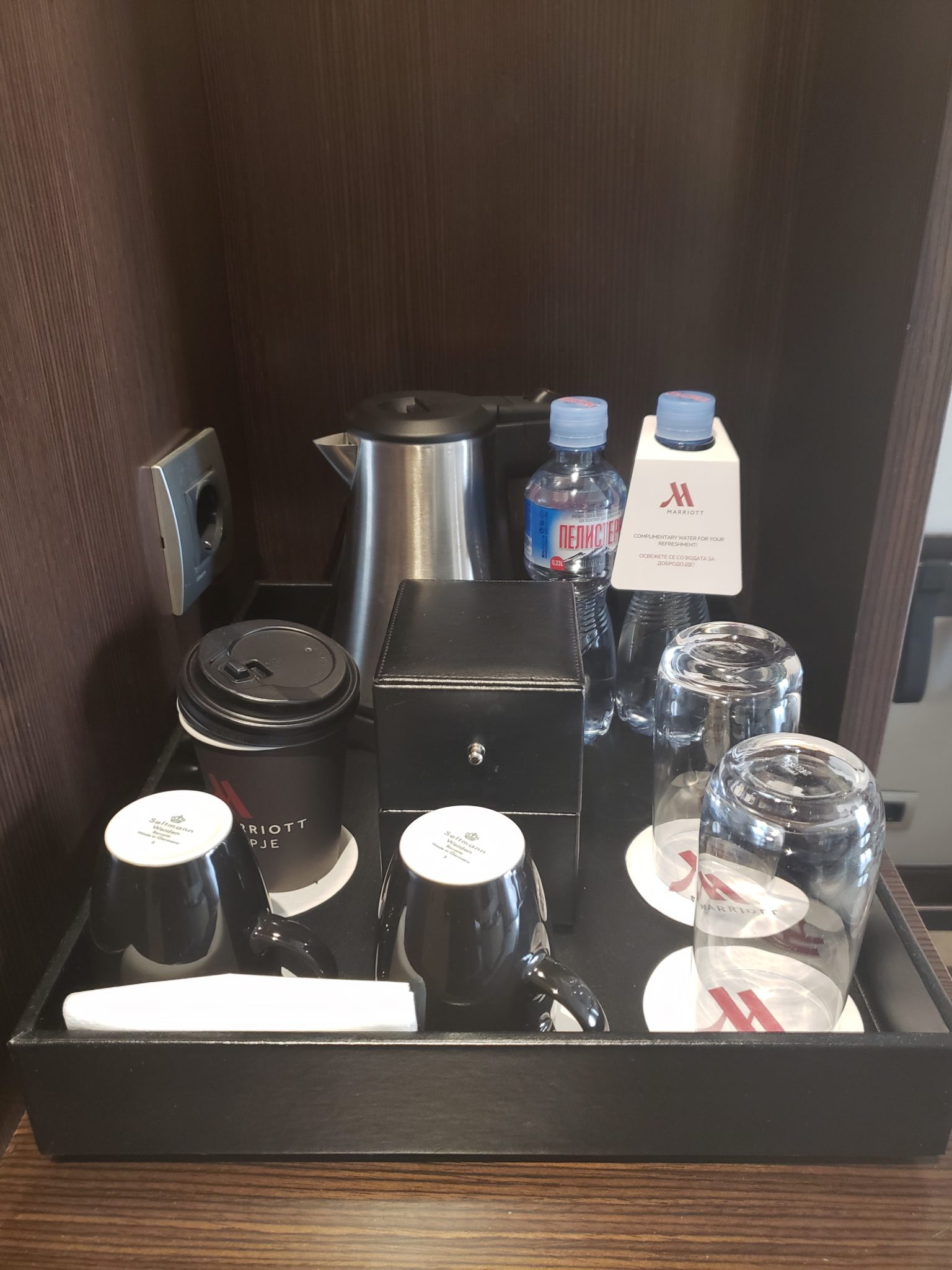 a tray of coffee cups and glasses