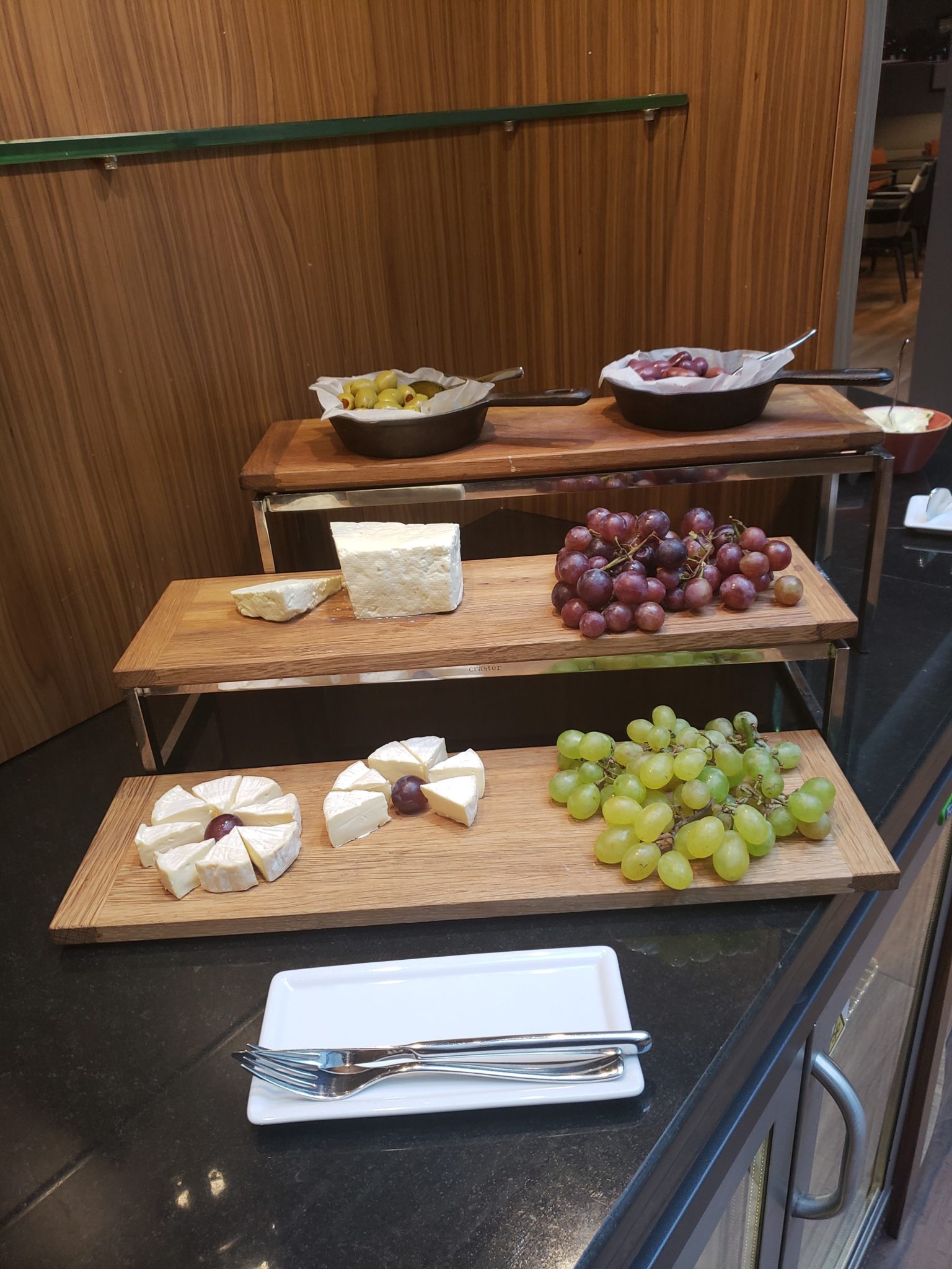 a trays of cheese and grapes on a table