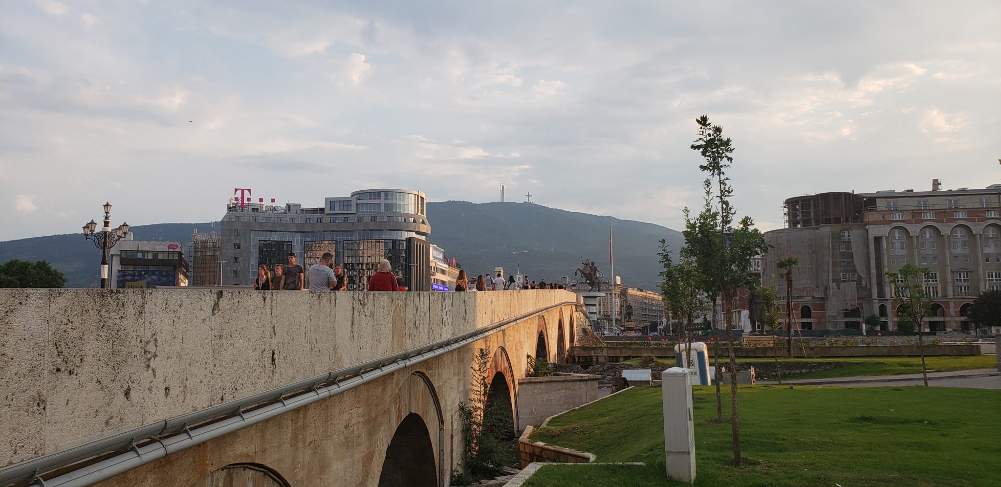 a stone bridge with people walking on it
