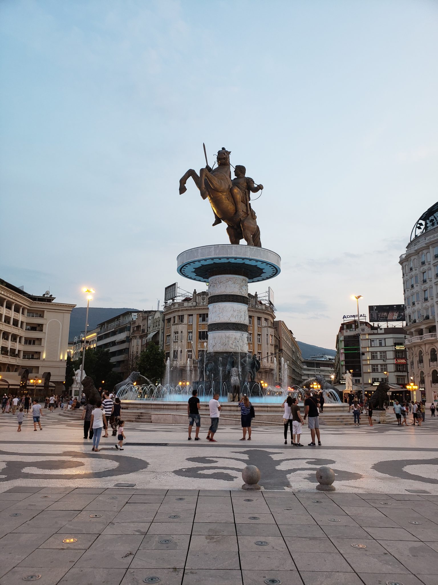 a large statue of a man riding a horse on a pedestal in a city