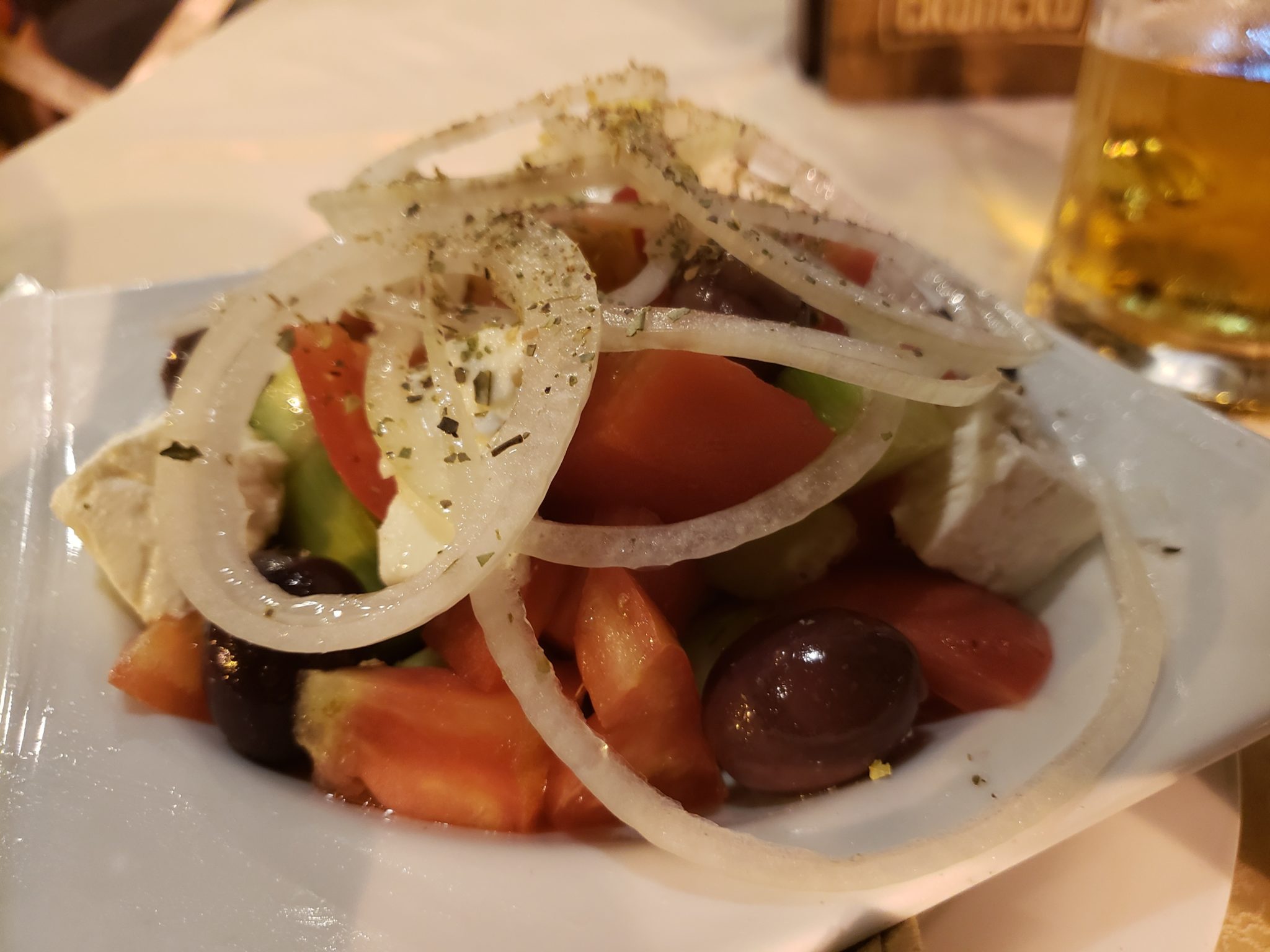 a plate of salad with onions and olives