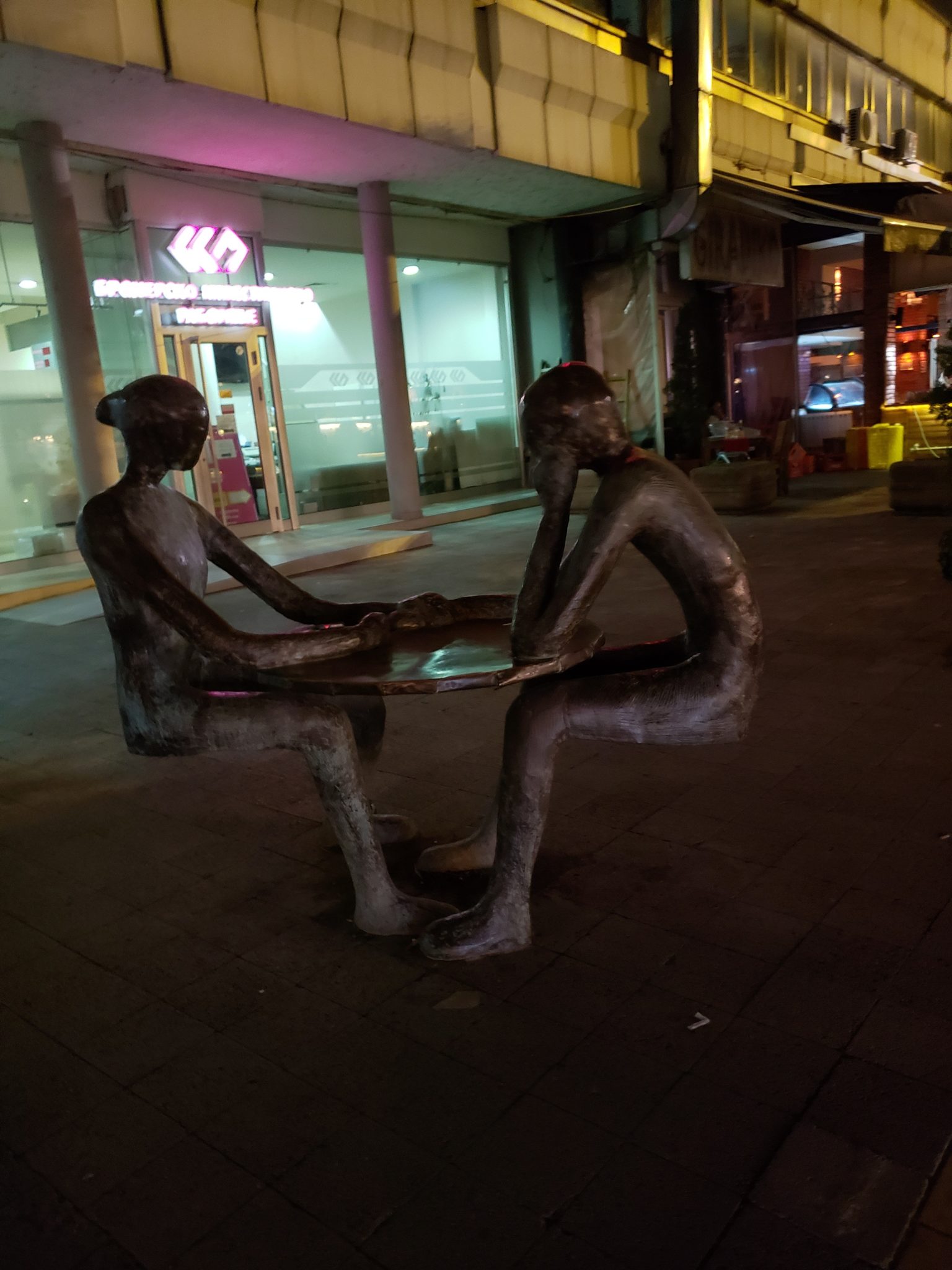 a statue of two people sitting at a table