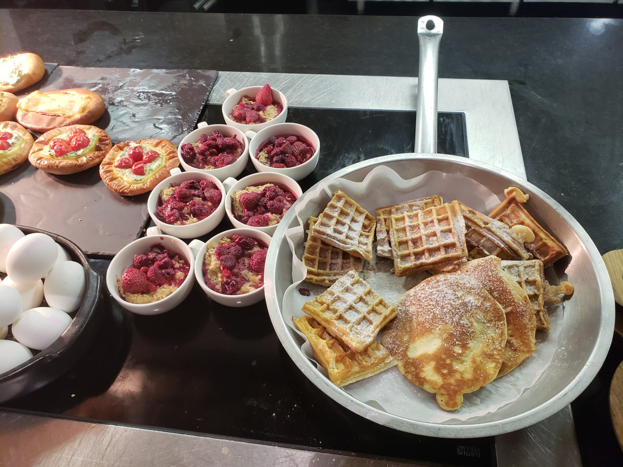 a pan of waffles and desserts on a table