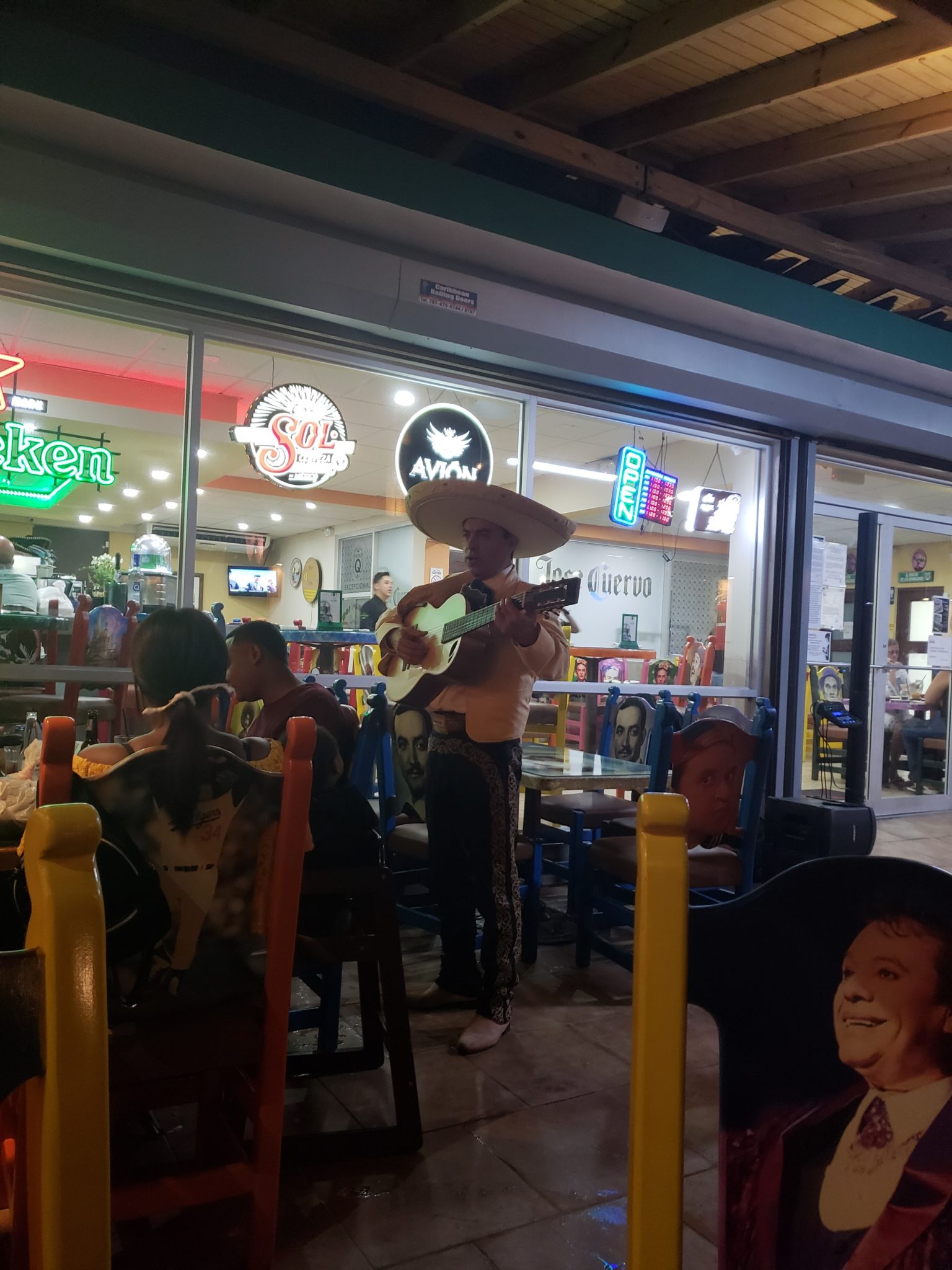 a man playing guitar in a restaurant